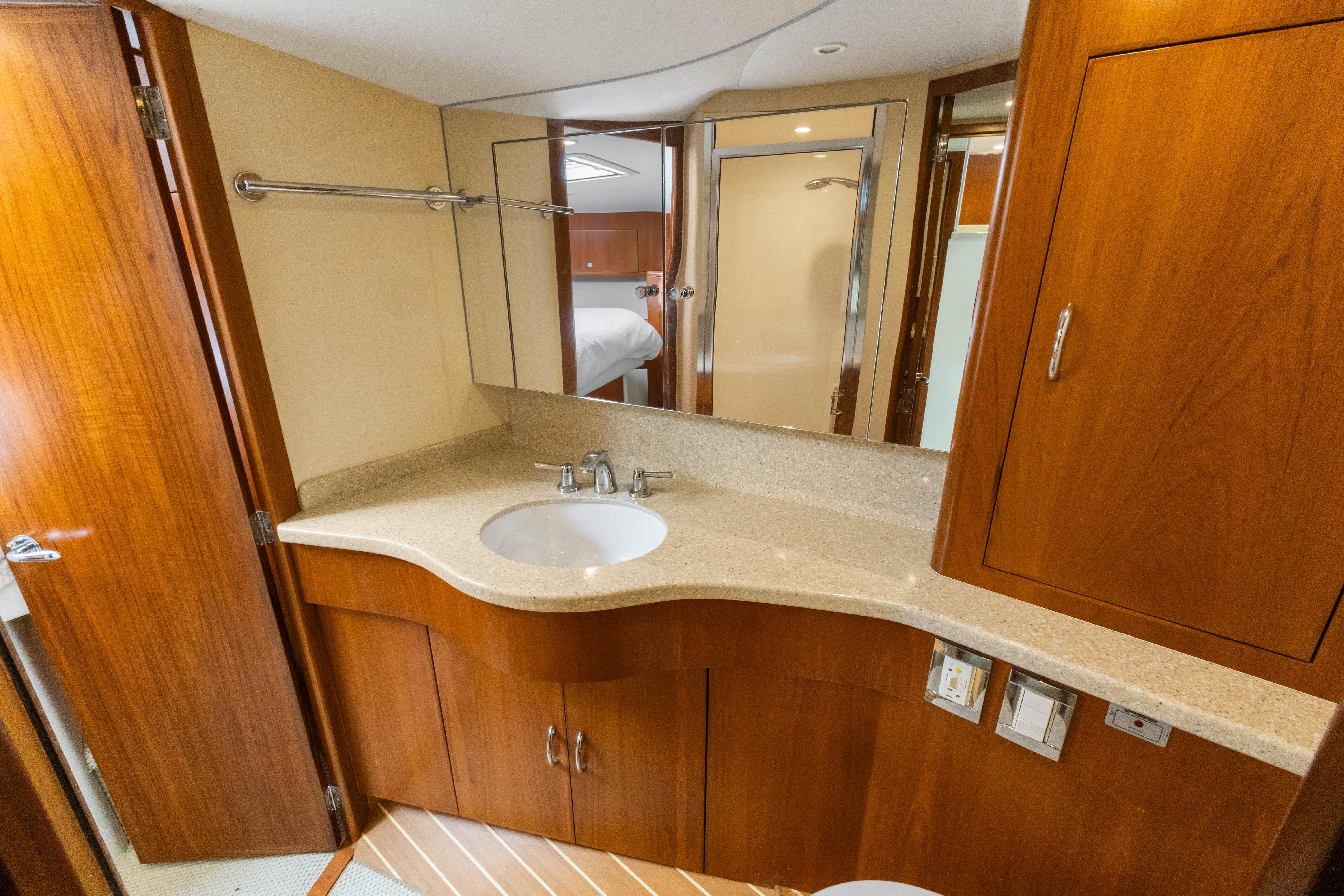 Cabo-40 Flybridge 2011-WELL PLAYED FL-US-Luxurious bathroom in 2011 Cabo 40 Flybridge yacht with wooden cabinetry and modern fixtures.-9659613 | Thumbnail