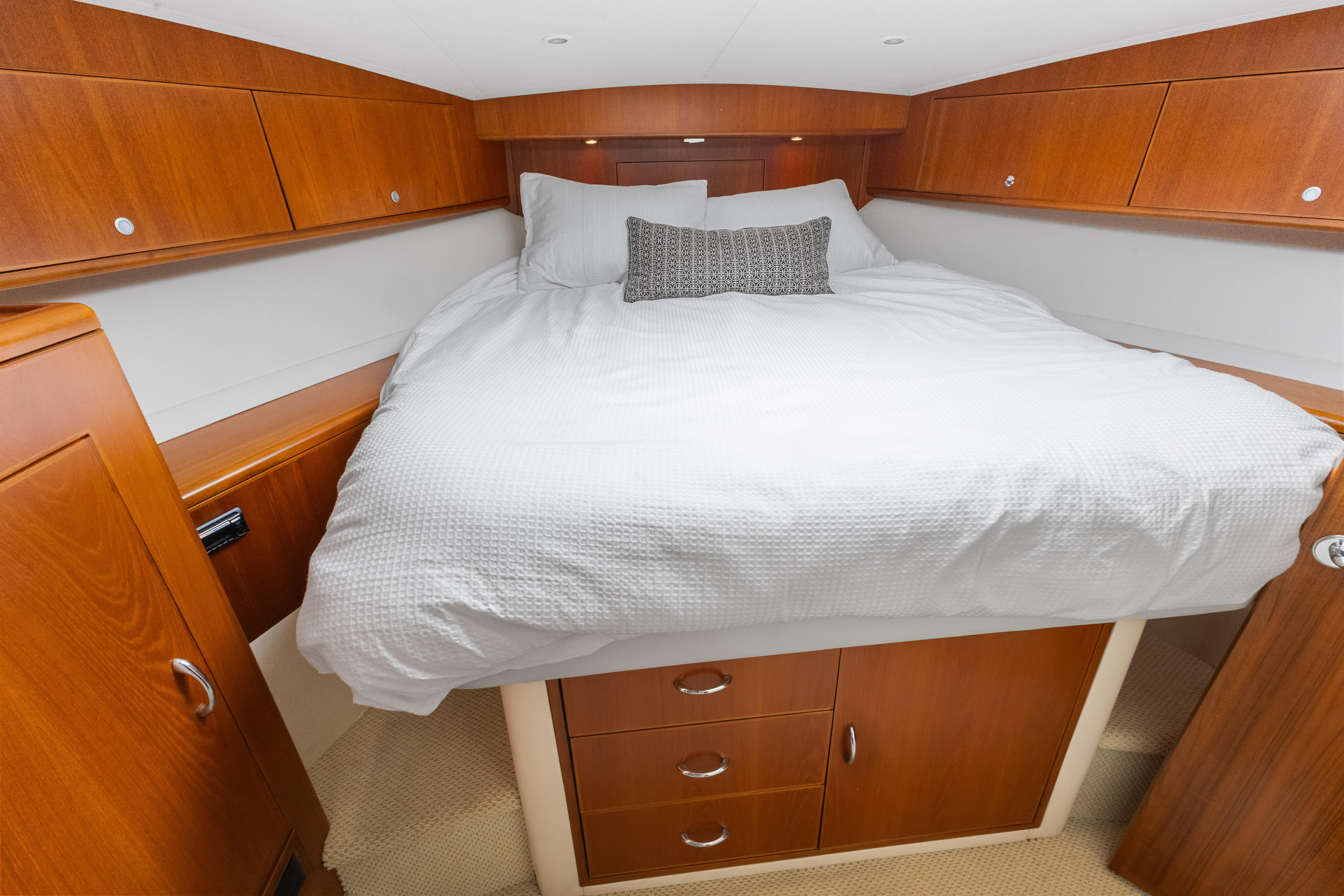 Cabo-40 Flybridge 2011-WELL PLAYED FL-US-Luxurious cabin interior of 2011 Cabo 40 Flybridge yacht with cozy bed and wooden cabinetry.-9659613 | Thumbnail