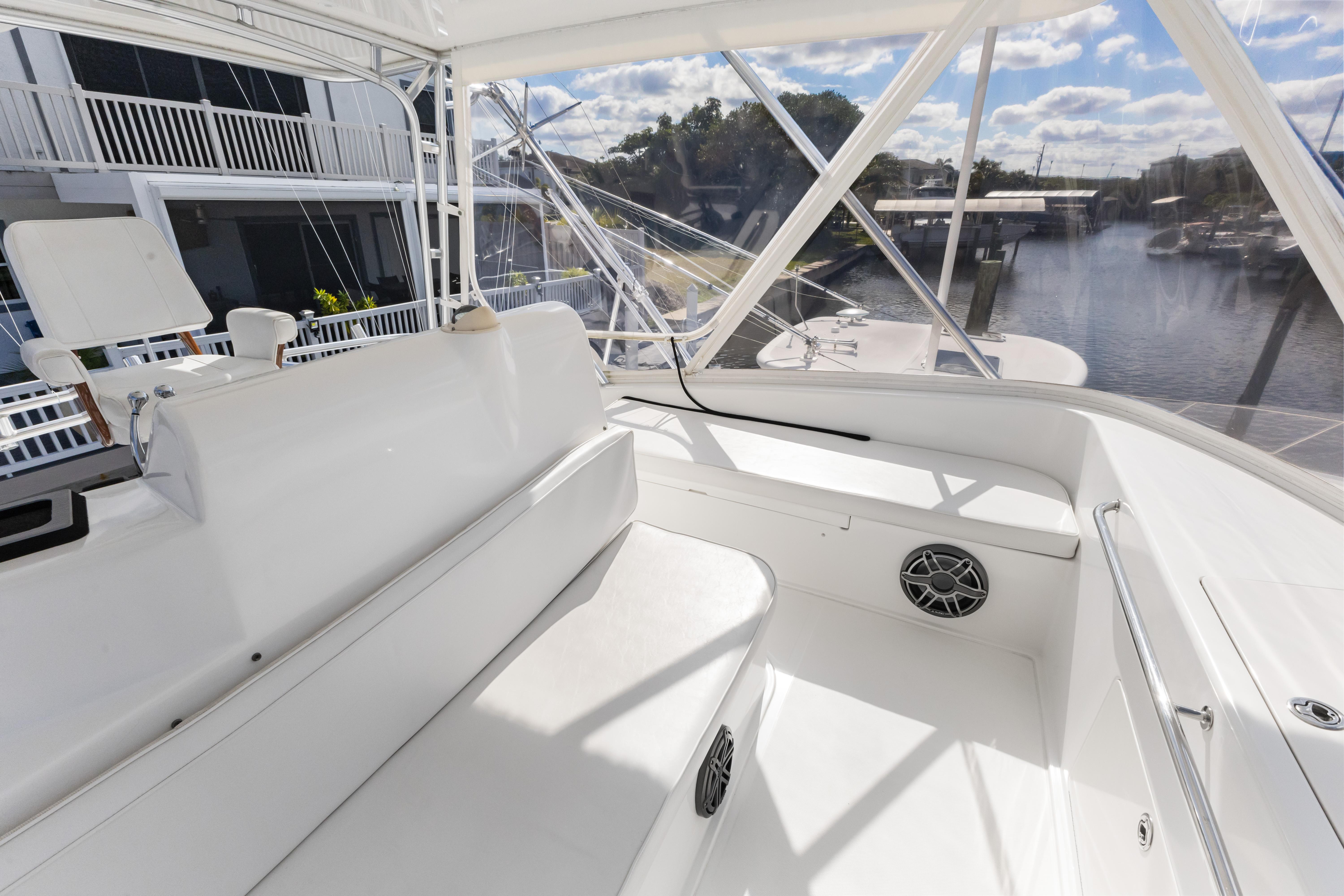 Cabo-40 Flybridge 2011-WELL PLAYED FL-US-2011 Cabo 40 Flybridge interior with white seating and marina view.-9659613 | Thumbnail
