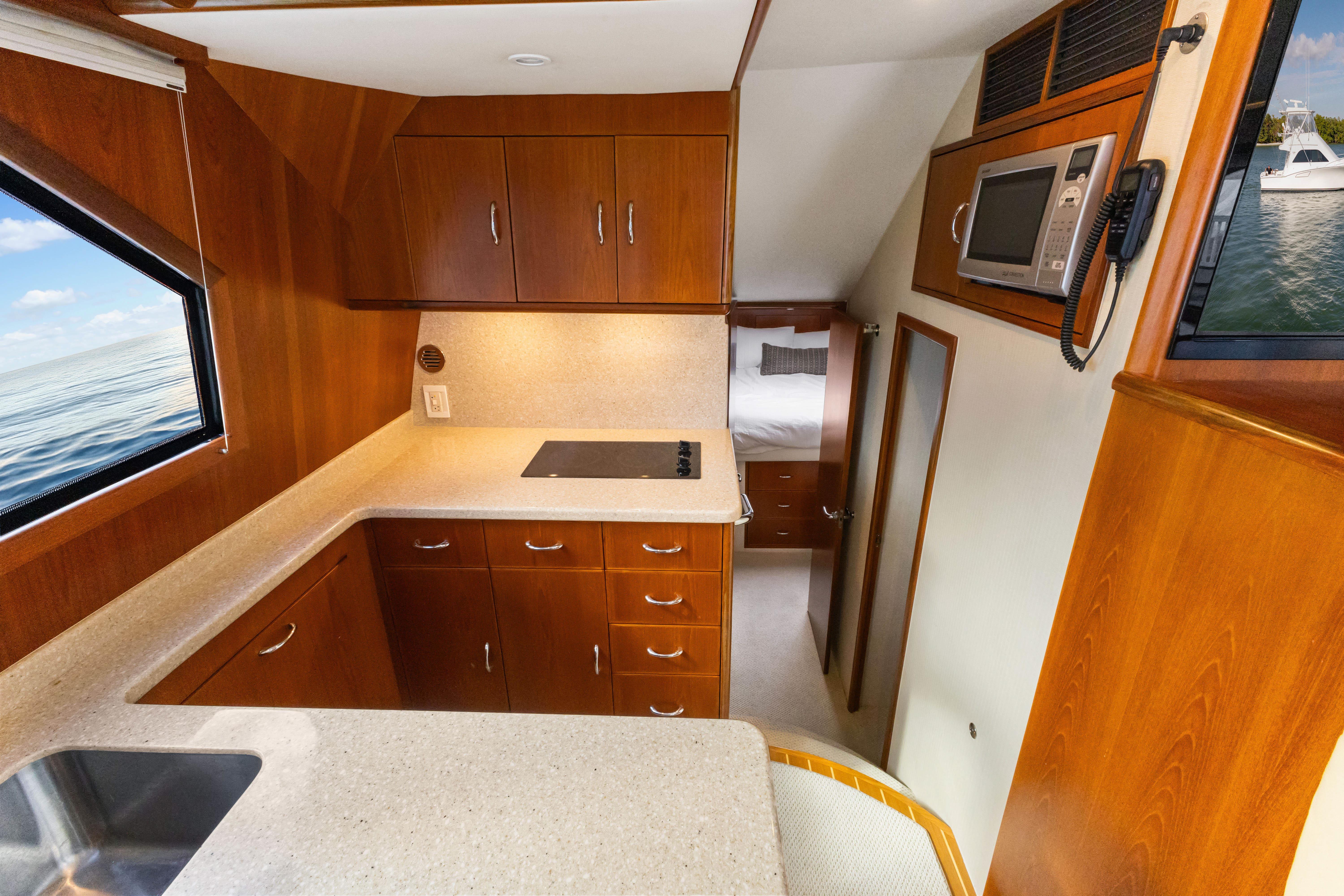 Cabo-40 Flybridge 2011-WELL PLAYED FL-US-Interior of 2011 Cabo 40 Flybridge yacht with modern kitchen and wood cabinetry.-9659613 | Thumbnail