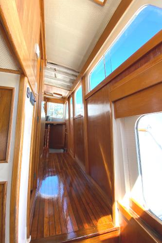 1977 Grand Alaskan Raised Pilothouse interior with polished wood and large windows.
