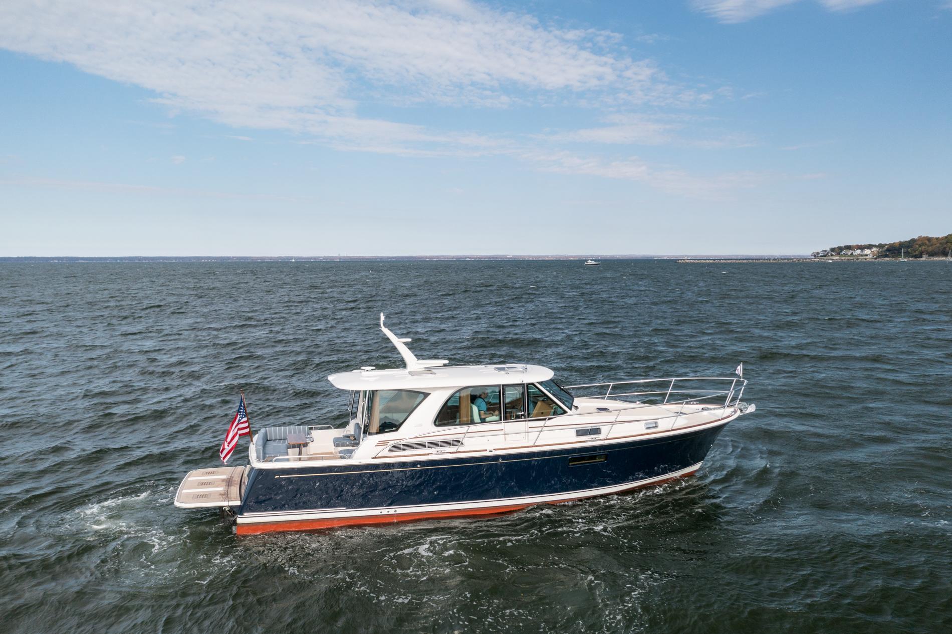 2025 Sabre 43 Salon Express yacht cruising on open water under a clear sky.
