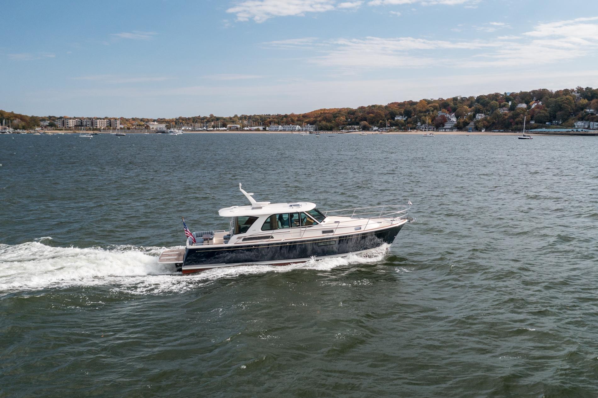 2025 Sabre 43 Salon Express cruising on a scenic coastal waterway.