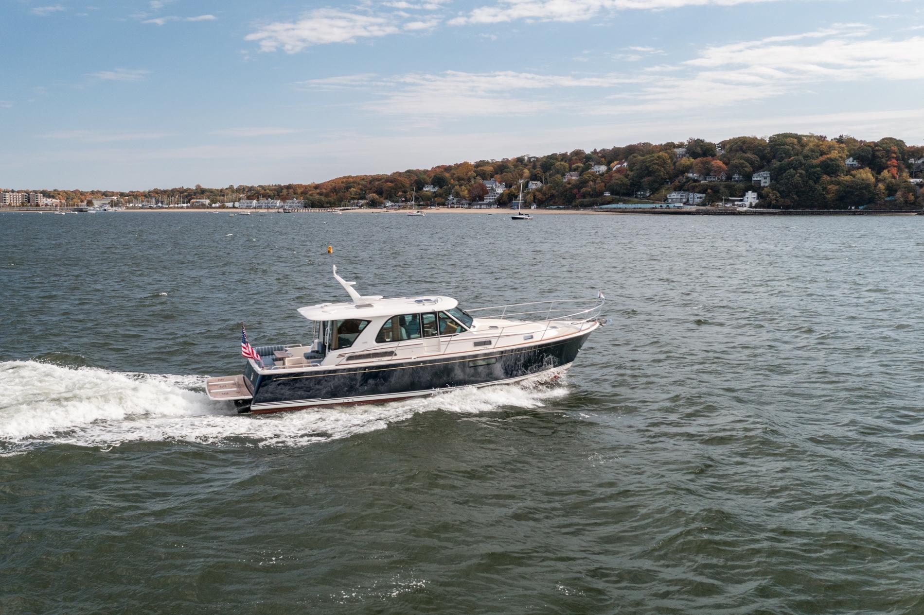 2025 Sabre 43 Salon Express cruising on a scenic coastal waterway.