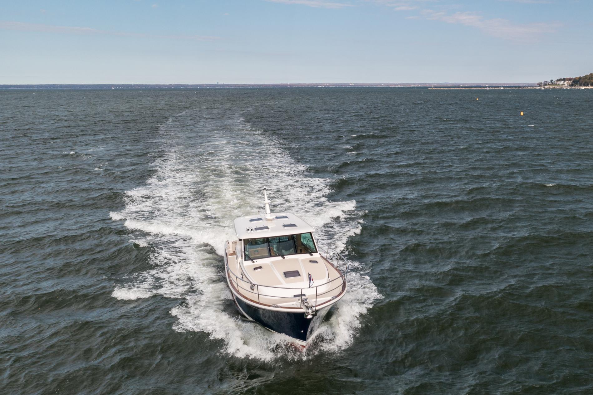 2025 Sabre 43 Salon Express cruising on open water, leaving a wake behind.