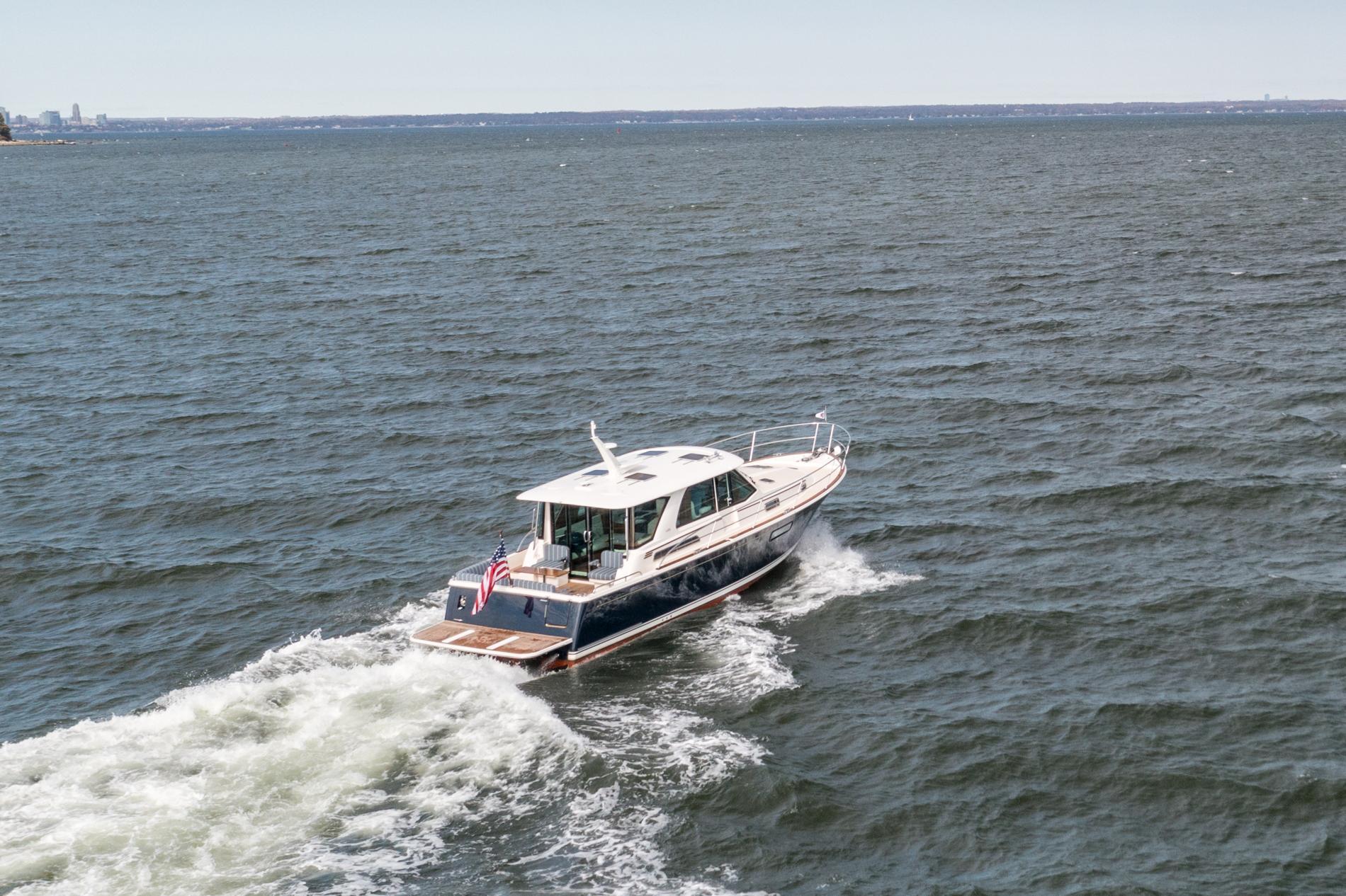 2025 Sabre 43 Salon Express cruising on open water, rear view.