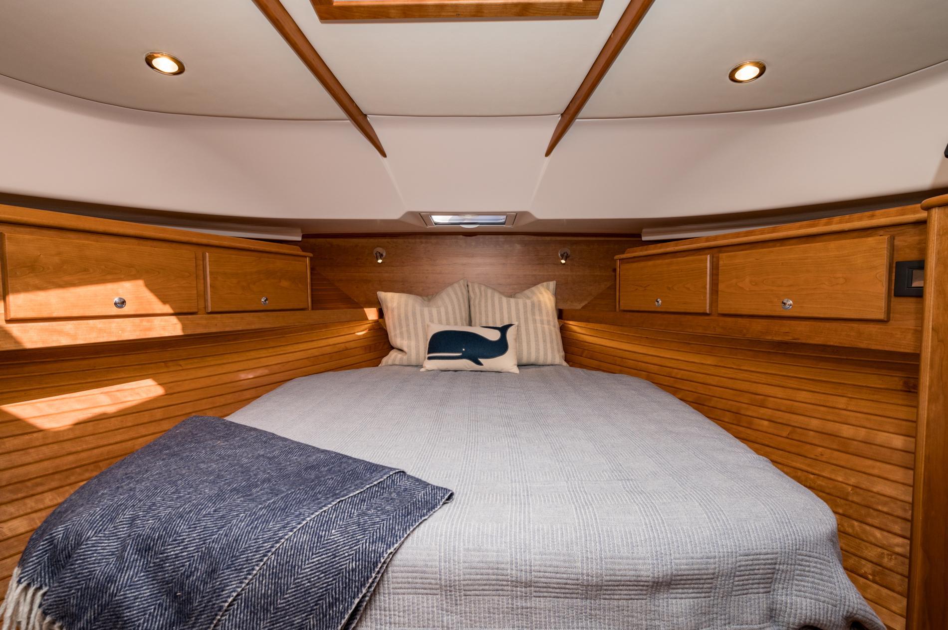 Luxurious cabin interior of 2025 Sabre 43 Salon Express yacht with cozy bedding.
