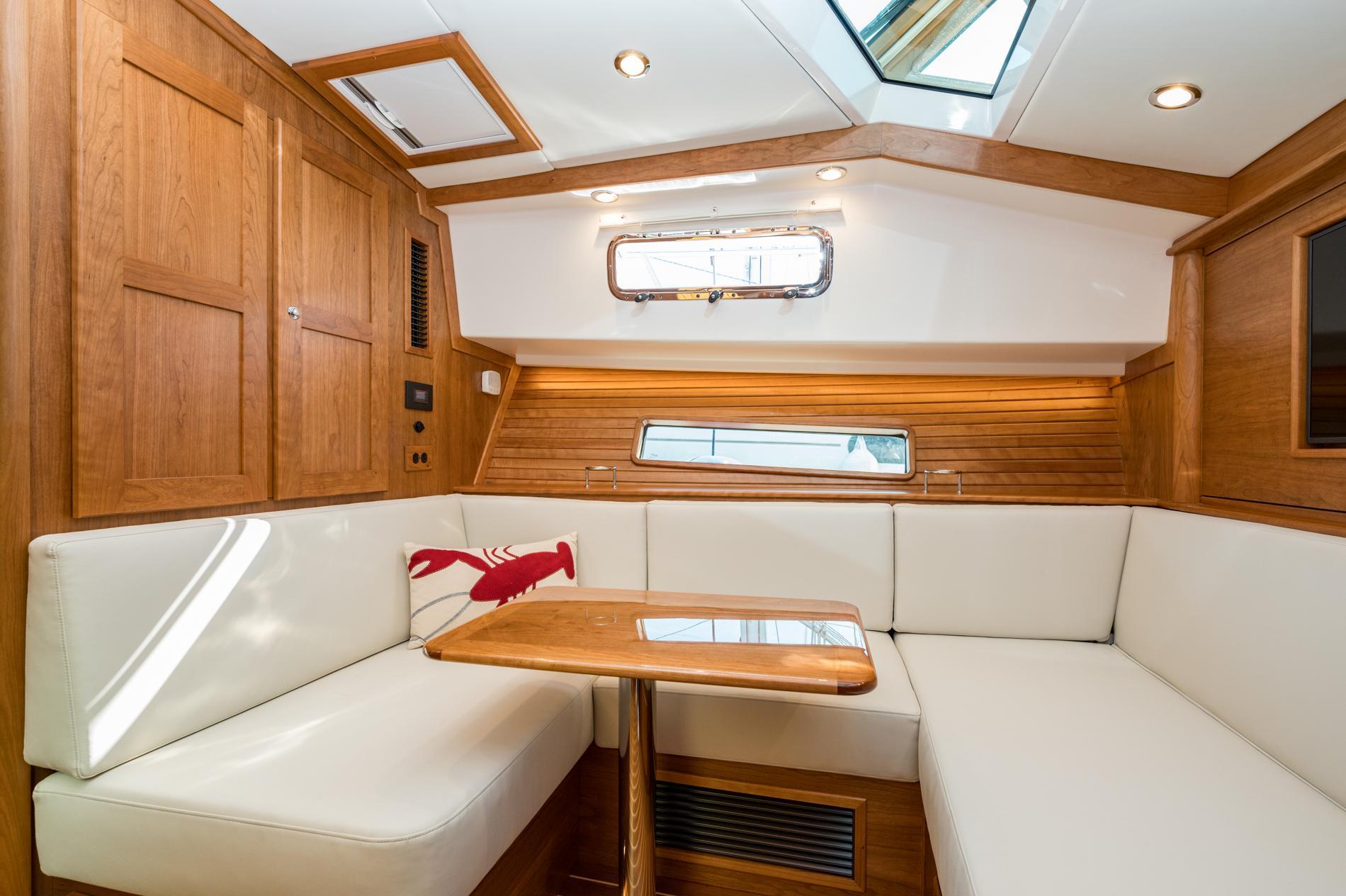 Luxurious interior of 2025 Sabre 43 Salon Express yacht with elegant wood finish and plush seating.
