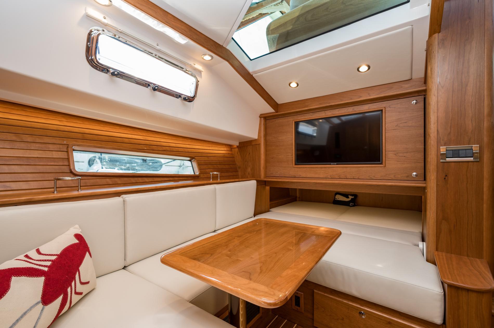 Luxurious interior of 2025 Sabre 43 Salon Express yacht with wood finish and plush seating.