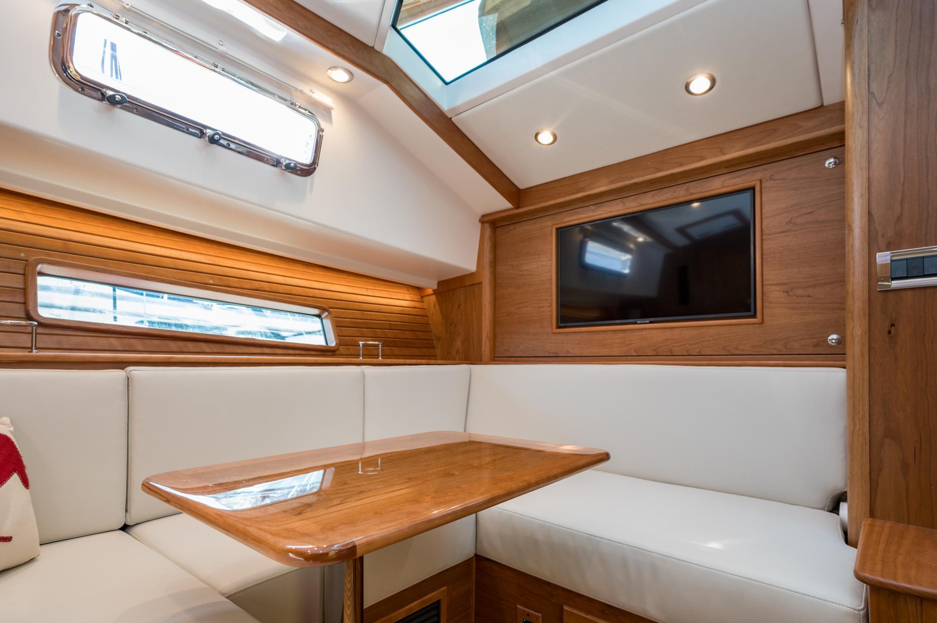 Luxurious interior of 2025 Sabre 43 Salon Express yacht with wood accents and seating.