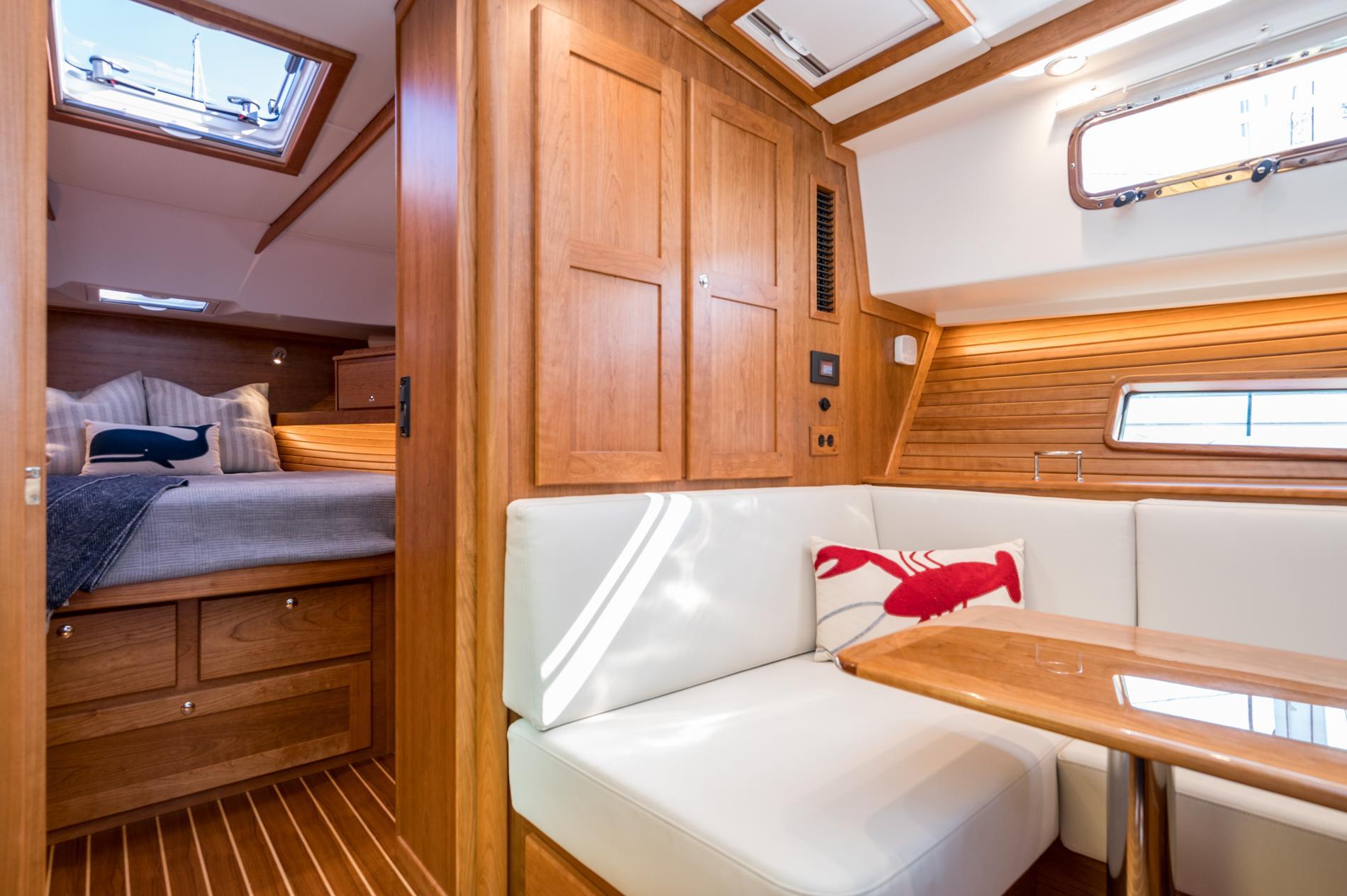 Luxurious interior of 2025 Sabre 43 Salon Express yacht with cozy seating and elegant wood finish.