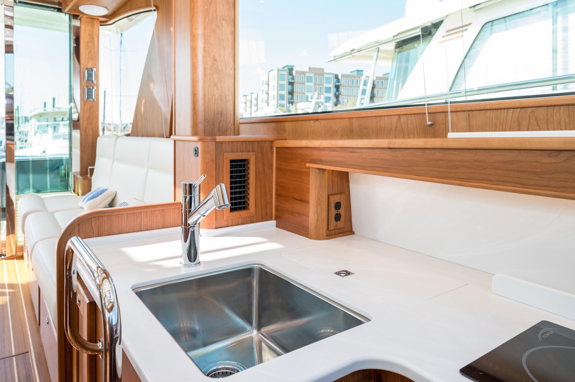 Luxurious interior of 2025 Sabre 43 Salon Express yacht with modern kitchen and seating area.