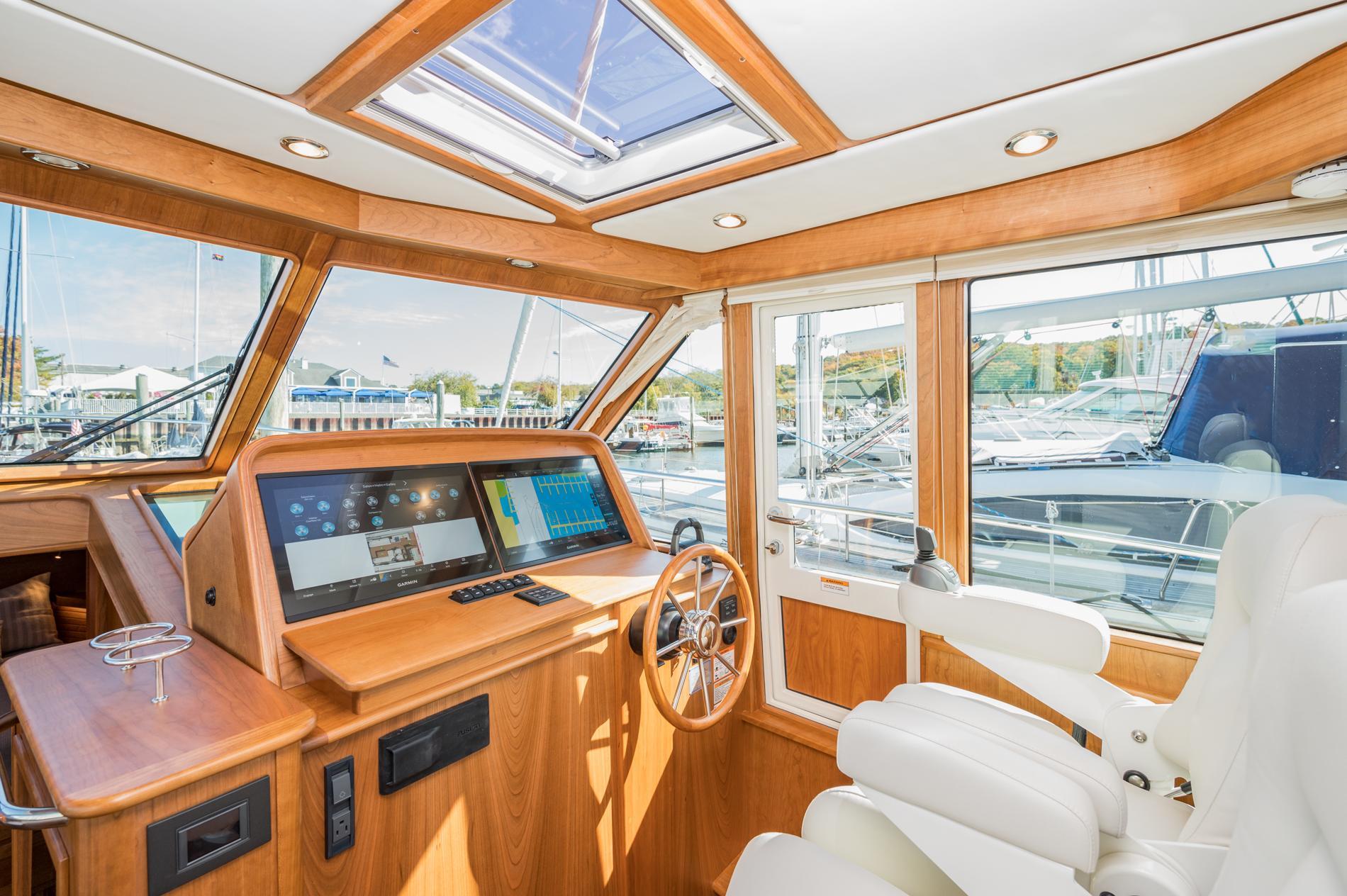 2025 Sabre 43 Salon Express yacht interior with modern helm and panoramic windows.