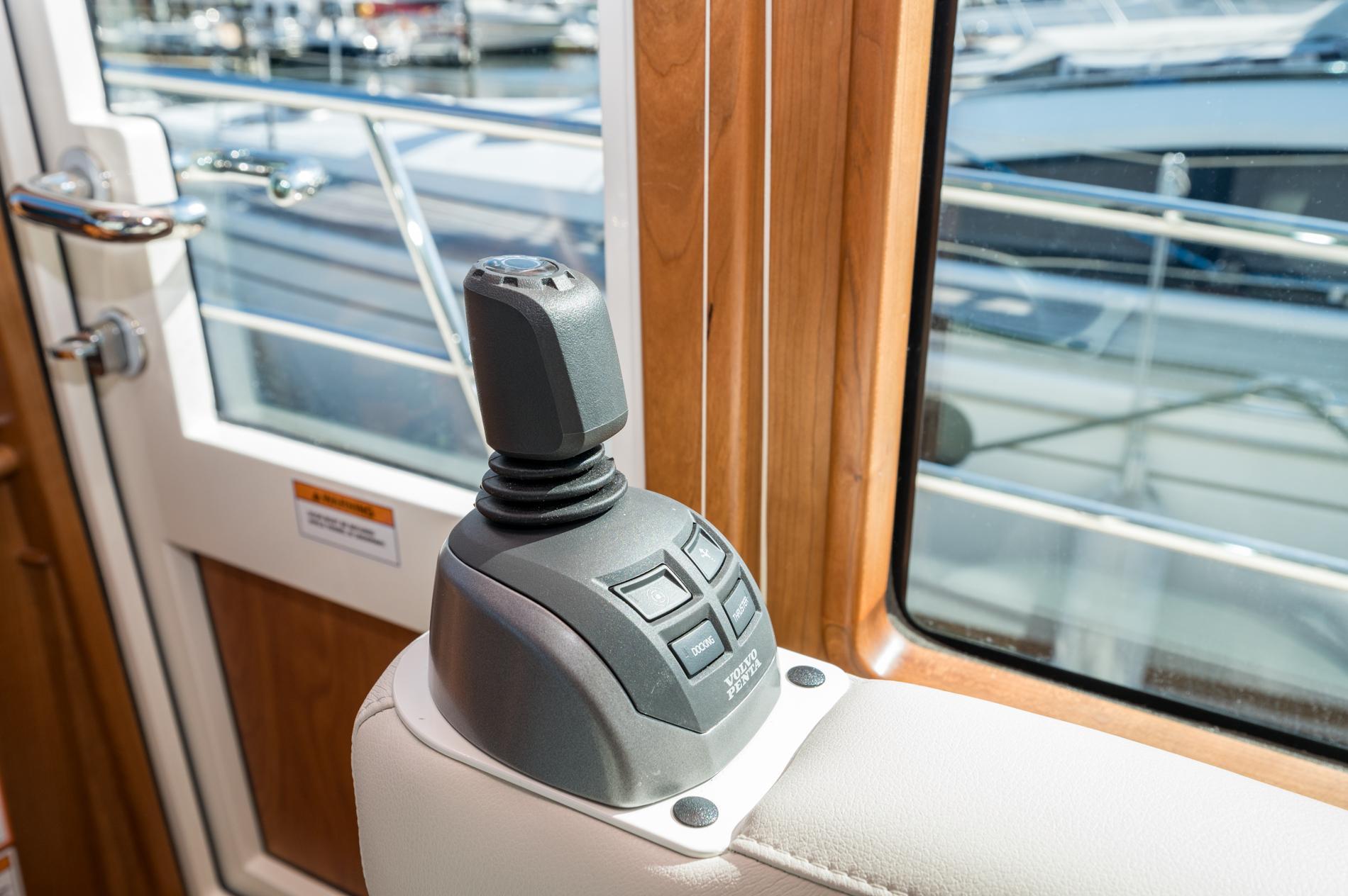 Joystick control in 2025 Sabre 43 Salon Express yacht interior, near window and door.