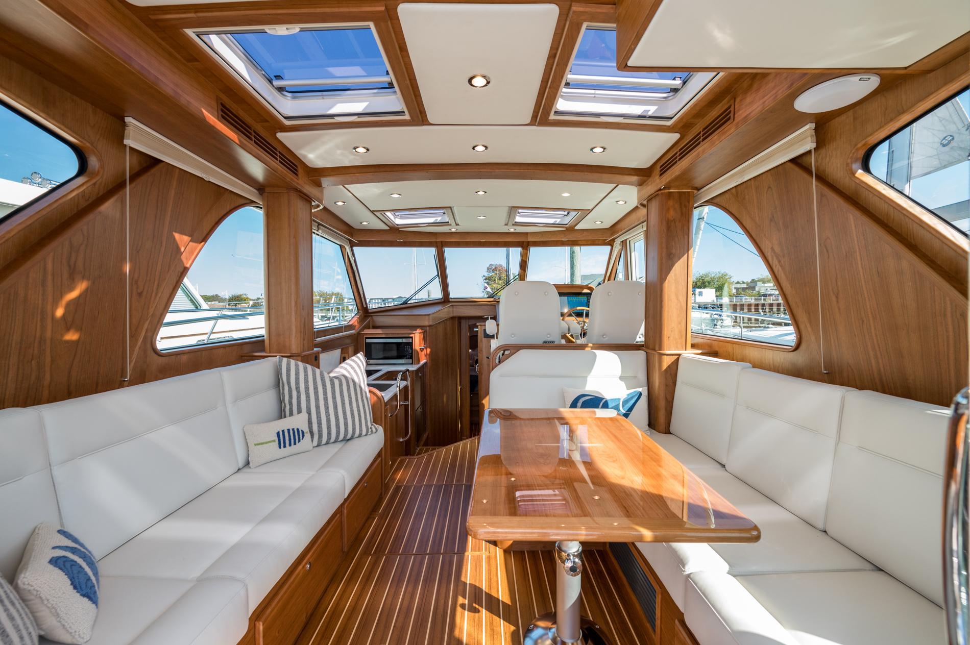 Luxurious interior of 2025 Sabre 43 Salon Express yacht with elegant wood finish and plush seating.