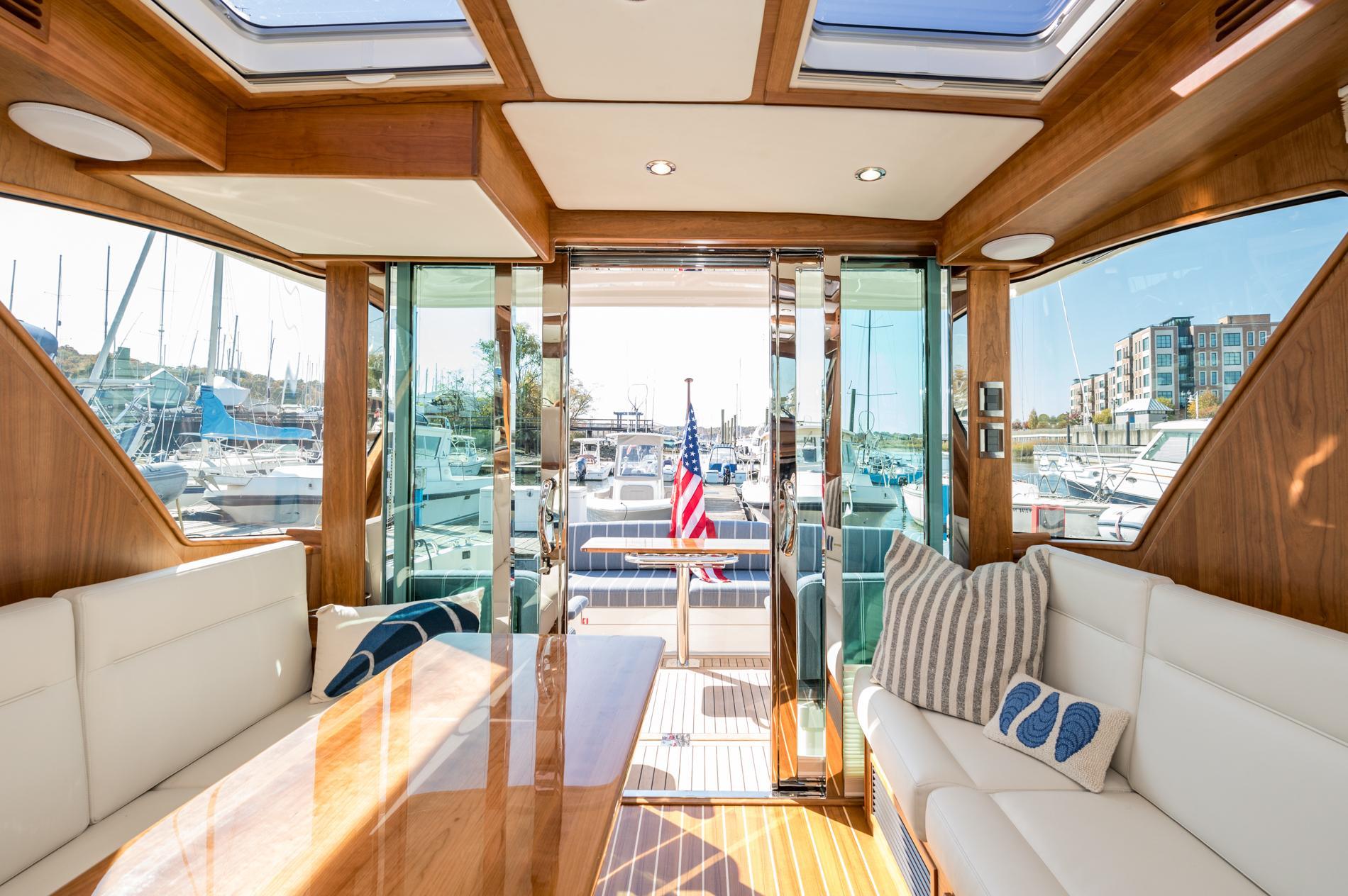 Luxurious interior of 2025 Sabre 43 Salon Express yacht with elegant wood finish and plush seating.