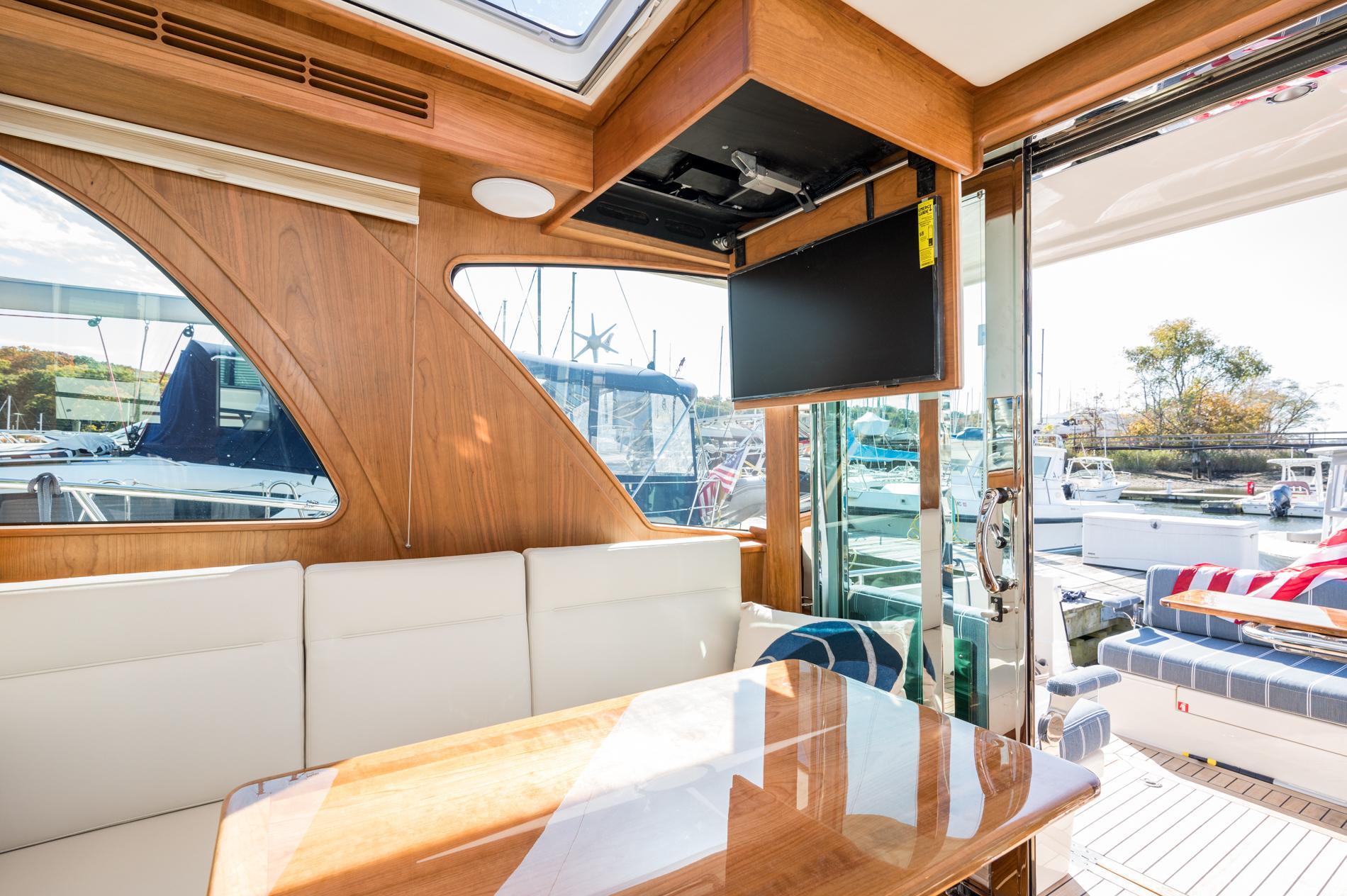 Luxurious interior of 2025 Sabre 43 Salon Express yacht with elegant wood finish and seating.