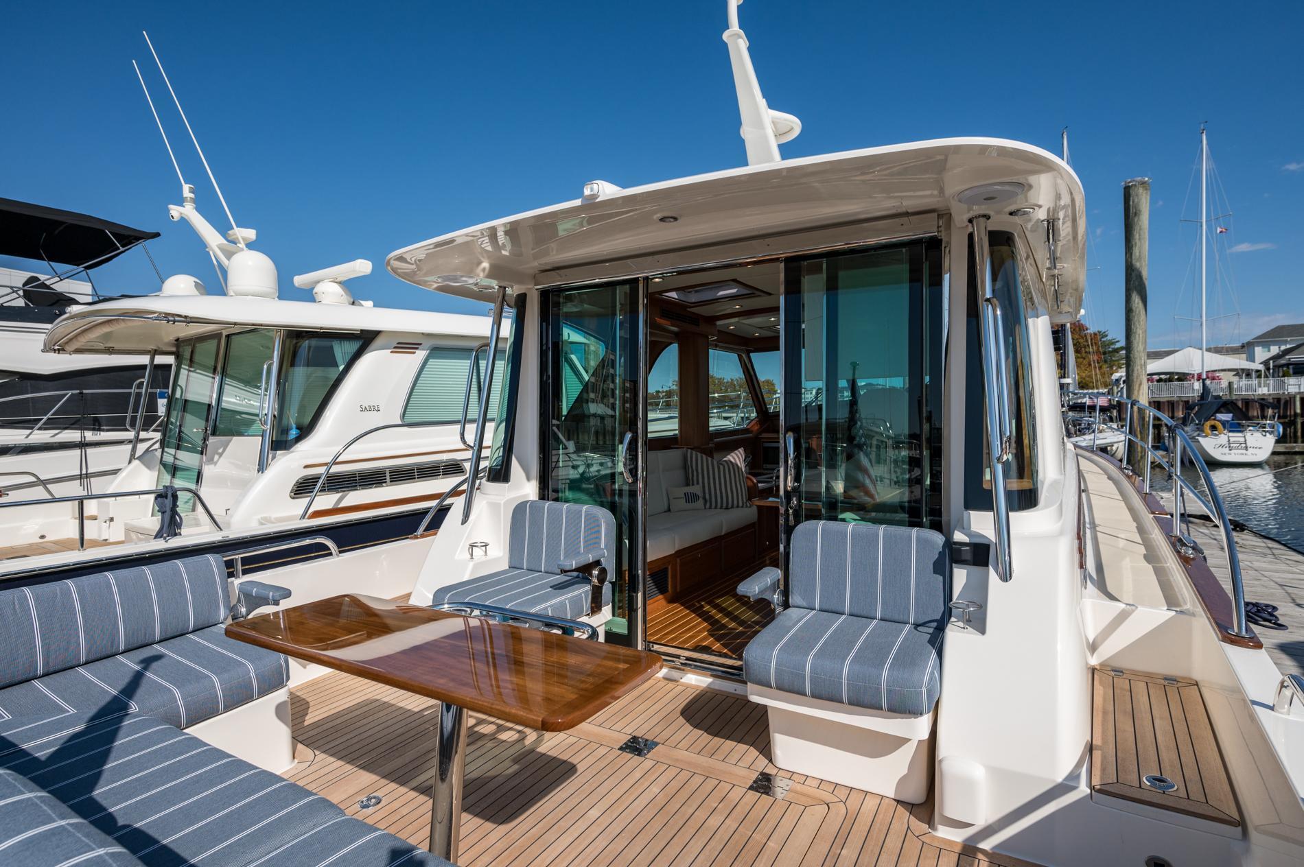 2025 Sabre 43 Salon Express yacht with elegant seating and wooden deck.