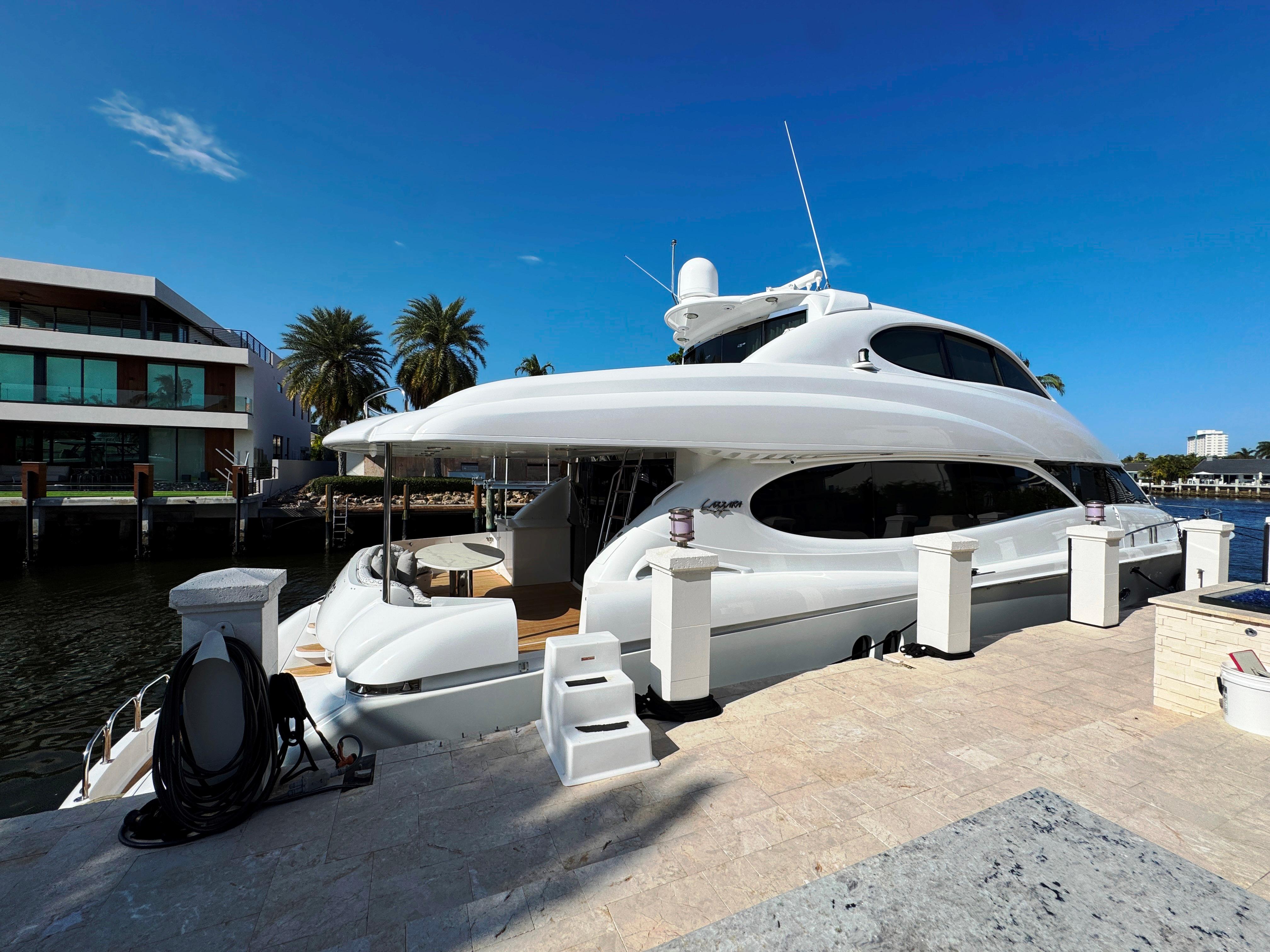 Lazzara-80 Skylounge 2002-Fomo2 FL-US-2002 Lazzara 80 Skylounge yacht docked by waterfront homes under clear blue sky.-9749638 | Thumbnail