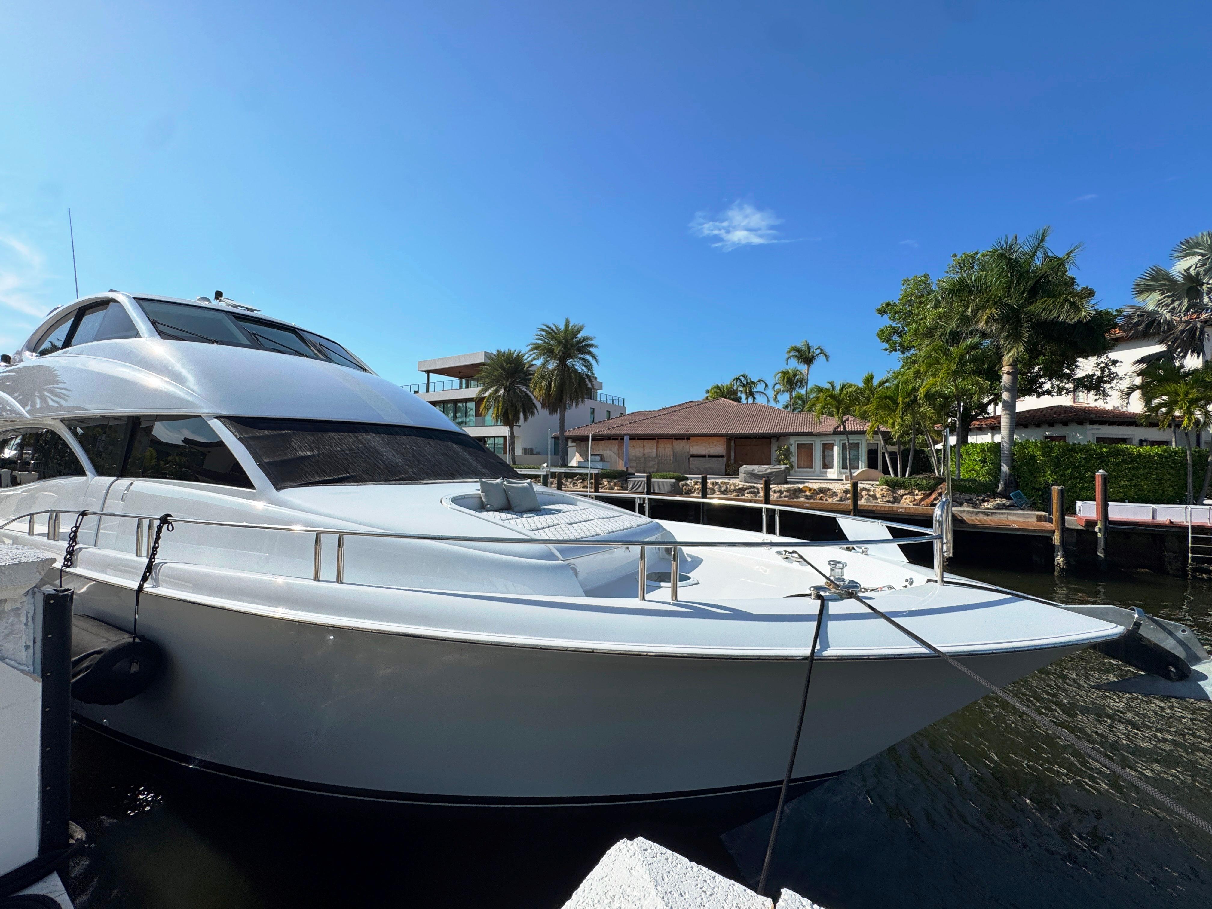 Lazzara-80 Skylounge 2002-Fomo2 FL-US-2002 Lazzara 80 Skylounge yacht docked by waterfront homes under clear blue sky.-9749638 | Thumbnail