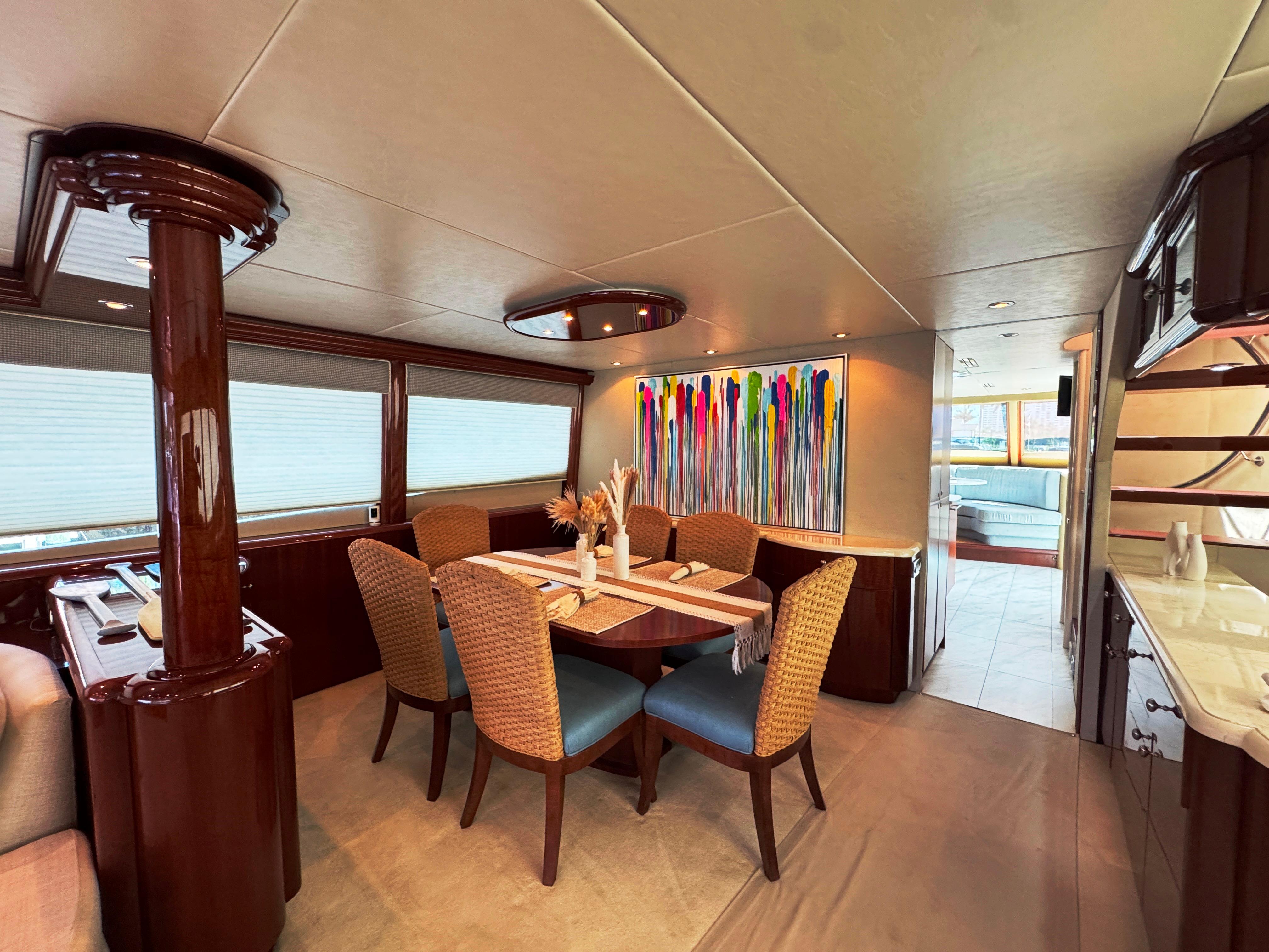 Lazzara-80 Skylounge 2002-Fomo2 FL-US-Luxurious dining area in 2002 Lazzara 80 Skylounge yacht with modern decor and vibrant artwork.-9749638 | Thumbnail