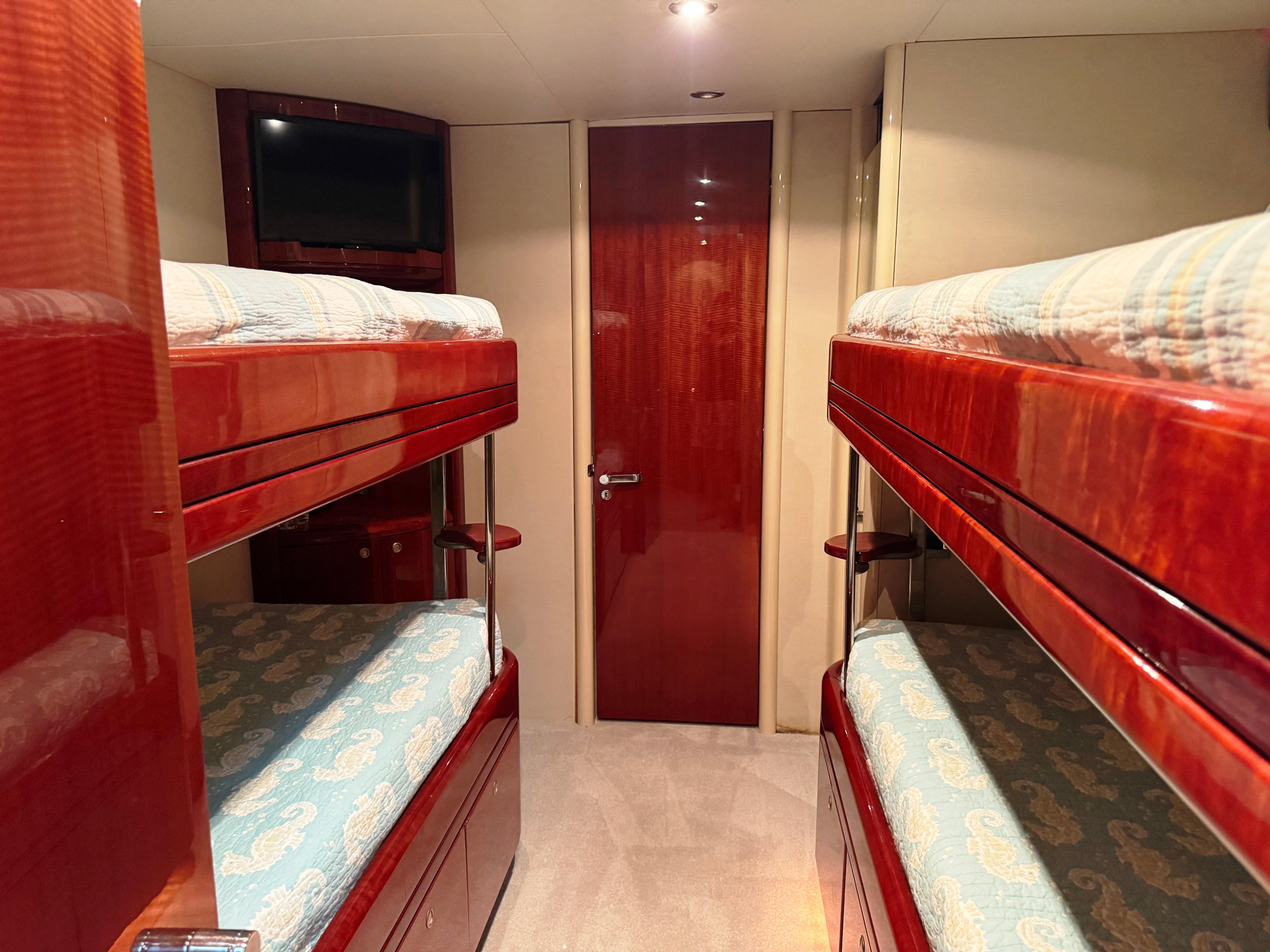 Lazzara-80 Skylounge 2002-Fomo2 FL-US-Interior of 2002 Lazzara 80 Skylounge yacht with wooden bunk beds and TV.-9749638 | Thumbnail