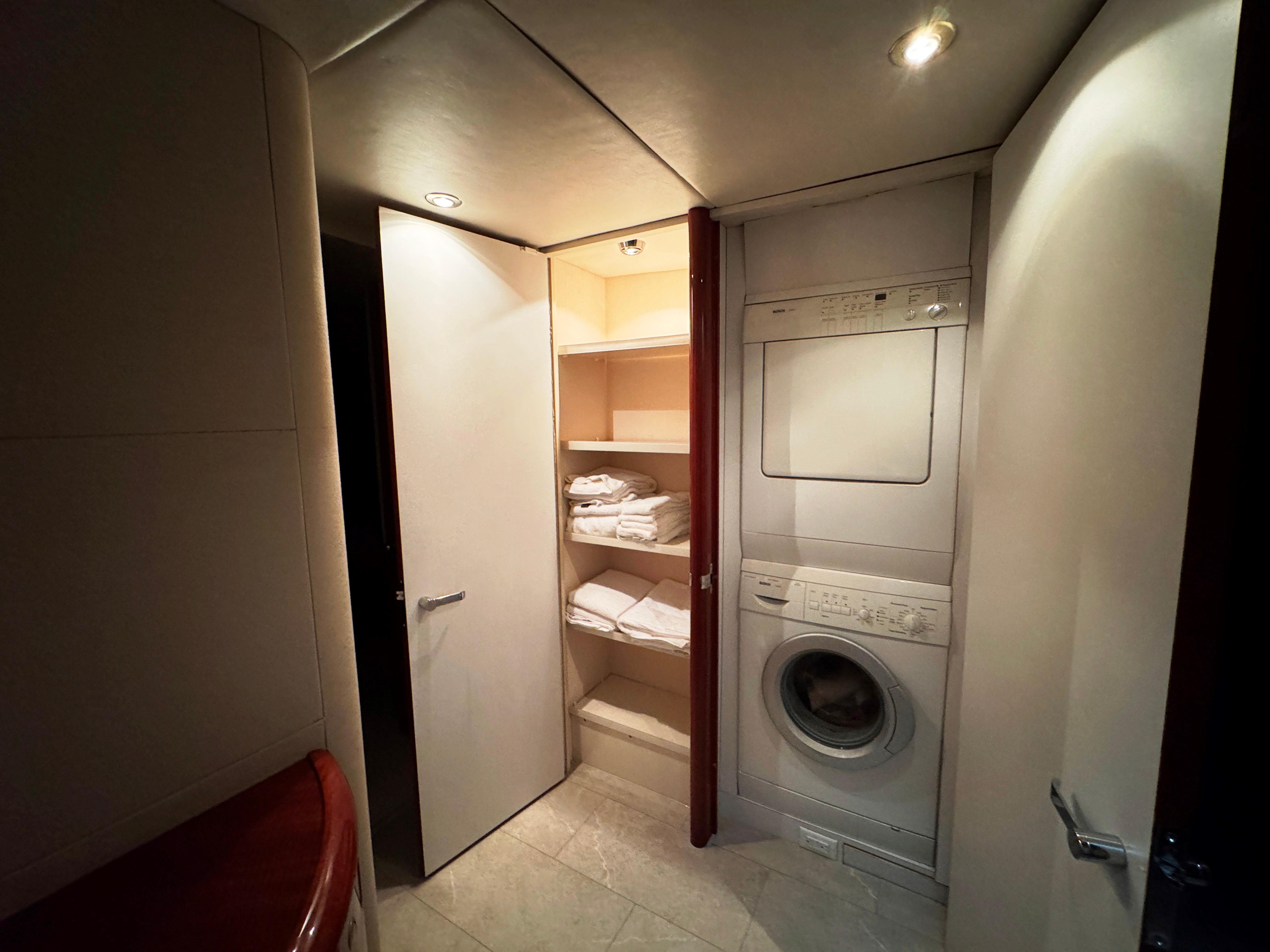 Lazzara-80 Skylounge 2002-Fomo2 FL-US-Laundry area with washer, dryer, and shelves in 2002 Lazzara 80 Skylounge yacht.-9749638 | Thumbnail