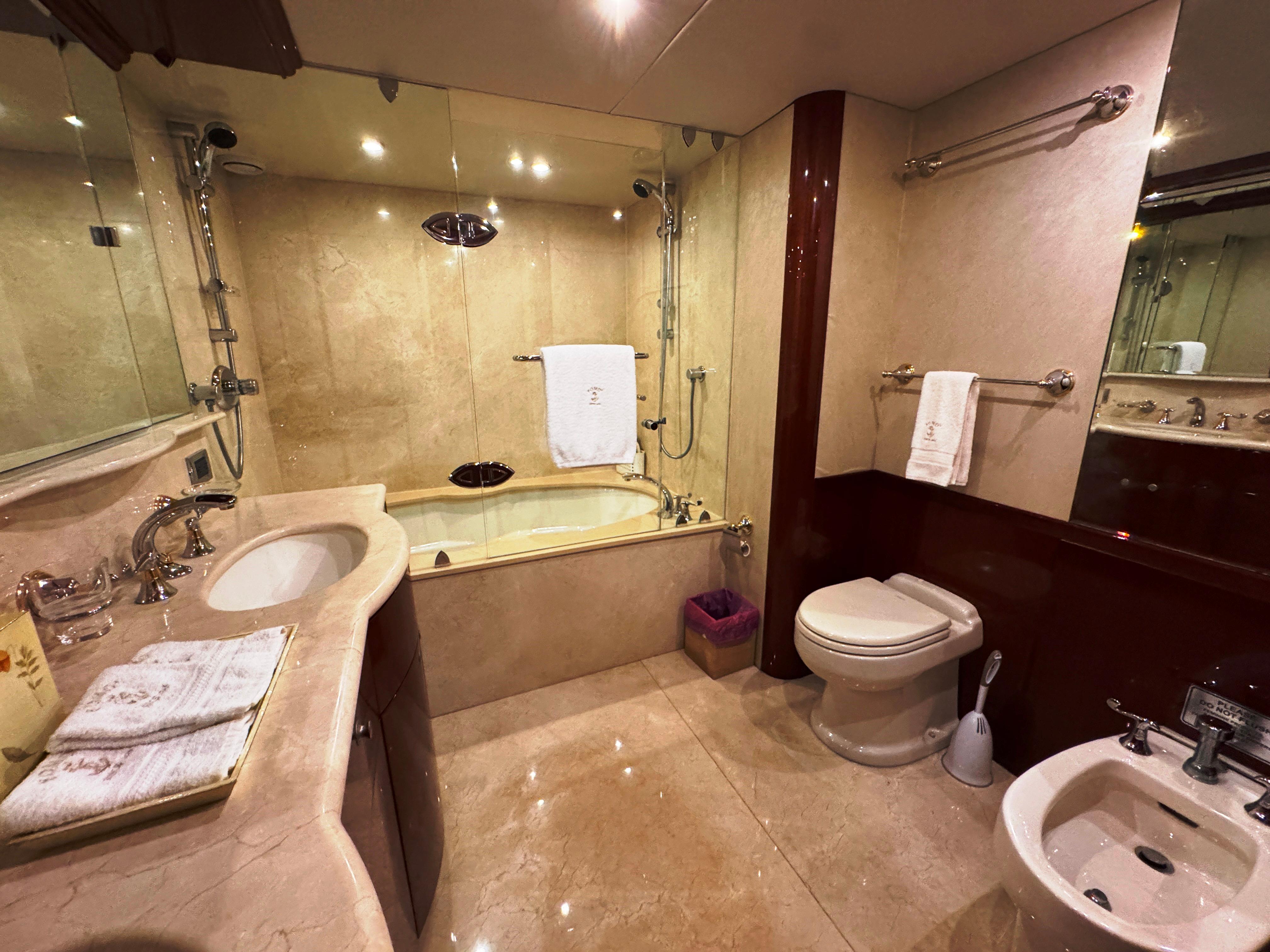 Lazzara-80 Skylounge 2002-Fomo2 FL-US-Luxurious bathroom in 2002 Lazzara 80 Skylounge yacht with marble finishes and elegant fixtures.-9749638 | Thumbnail