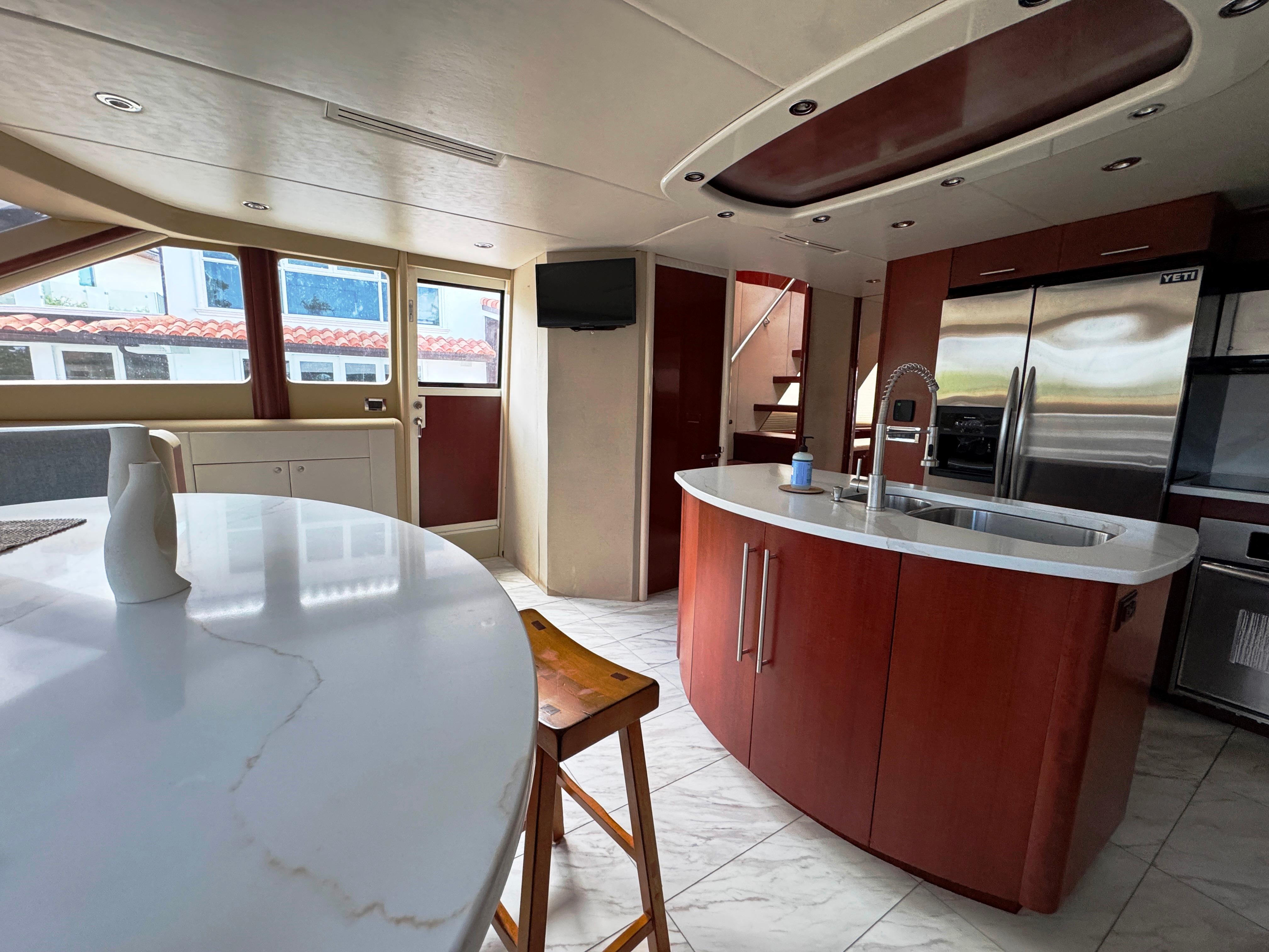 Lazzara-80 Skylounge 2002-Fomo2 FL-US-Luxurious interior of 2002 Lazzara 80 Skylounge yacht with modern kitchen and seating area.-9749638 | Thumbnail
