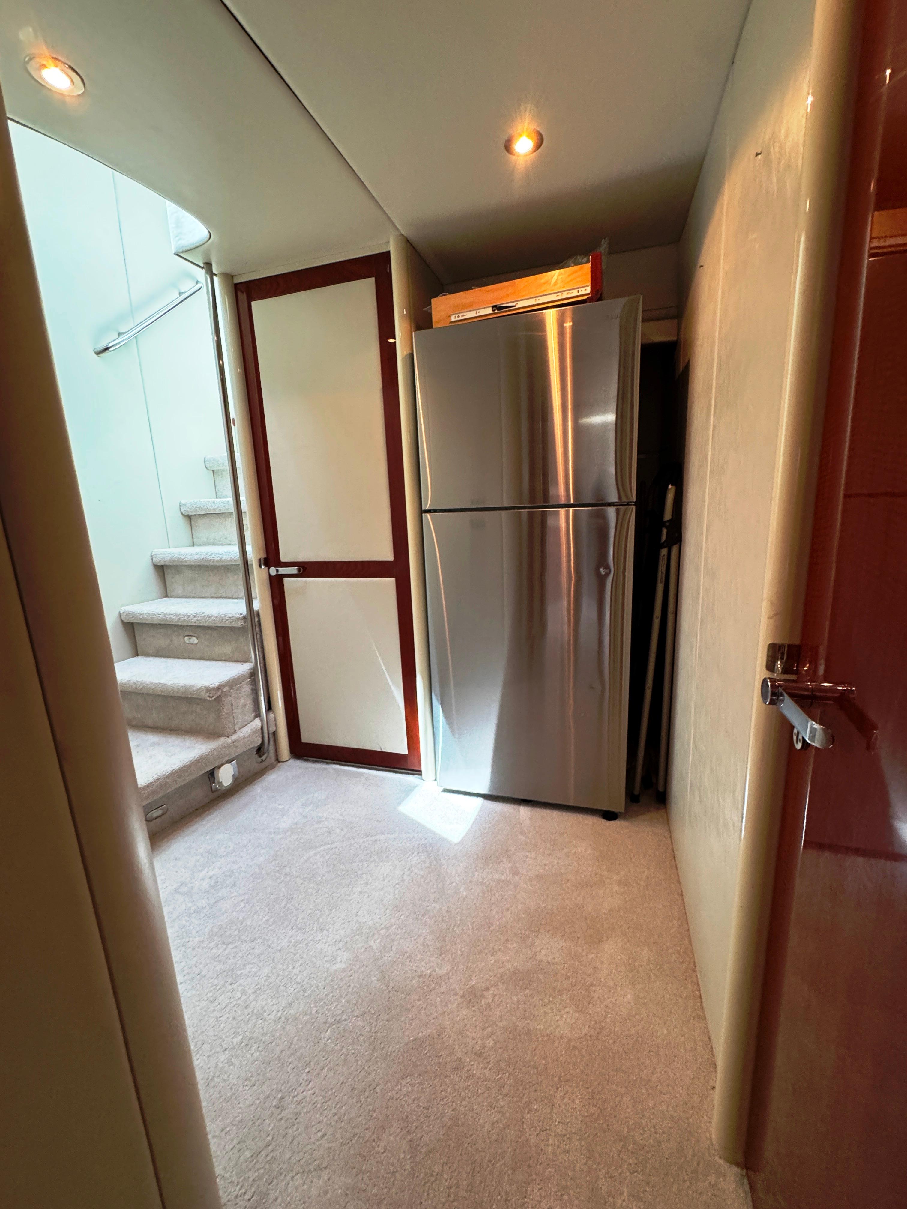 Lazzara-80 Skylounge 2002-Fomo2 FL-US-Interior of 2002 Lazzara 80 Skylounge yacht with stainless steel refrigerator and carpeted flooring.-9749638 | Thumbnail
