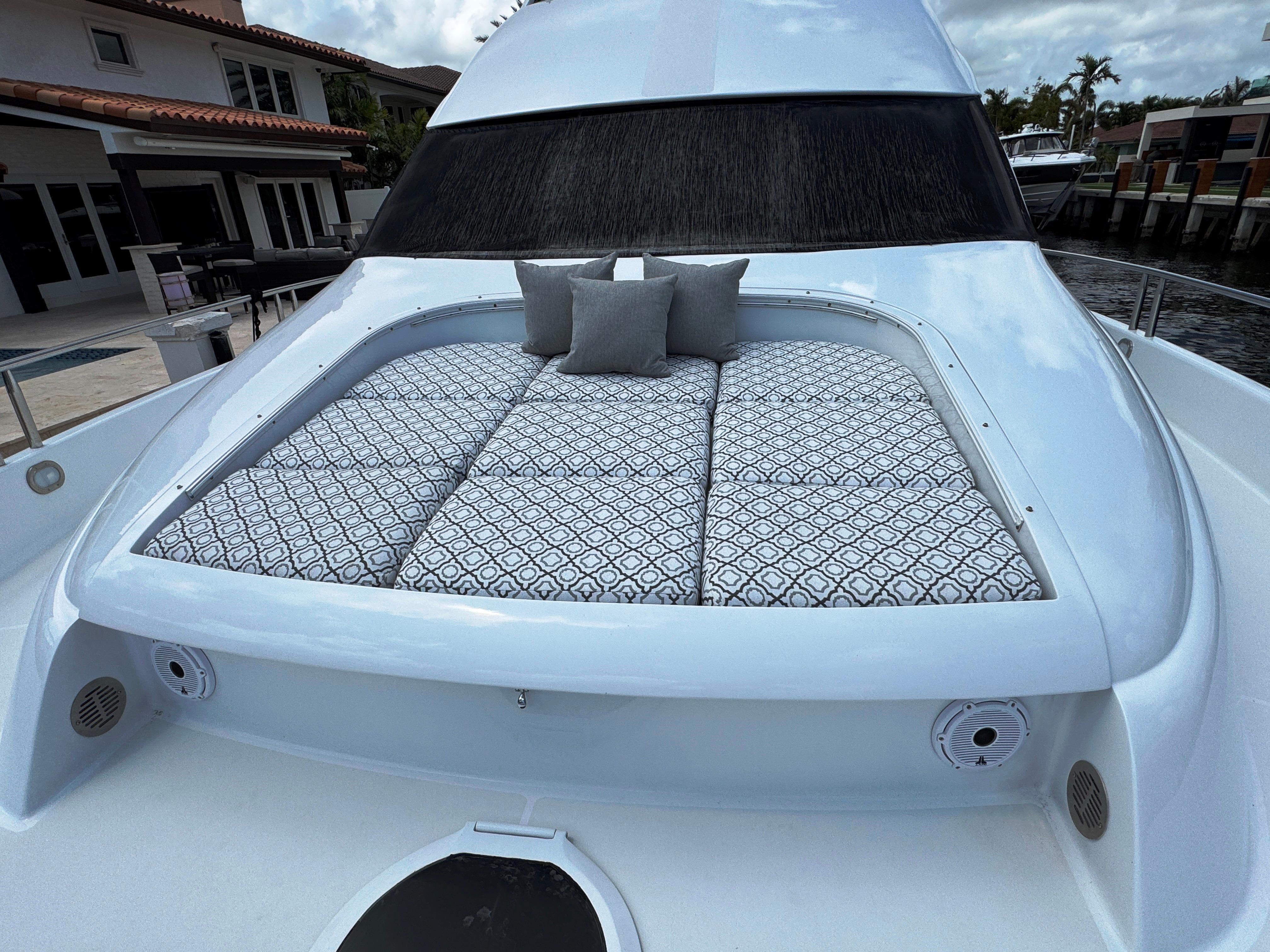 Lazzara-80 Skylounge 2002-Fomo2 FL-US-2002 Lazzara 80 Skylounge yacht with cushioned sunbathing area and decorative pillows.-9749638 | Thumbnail