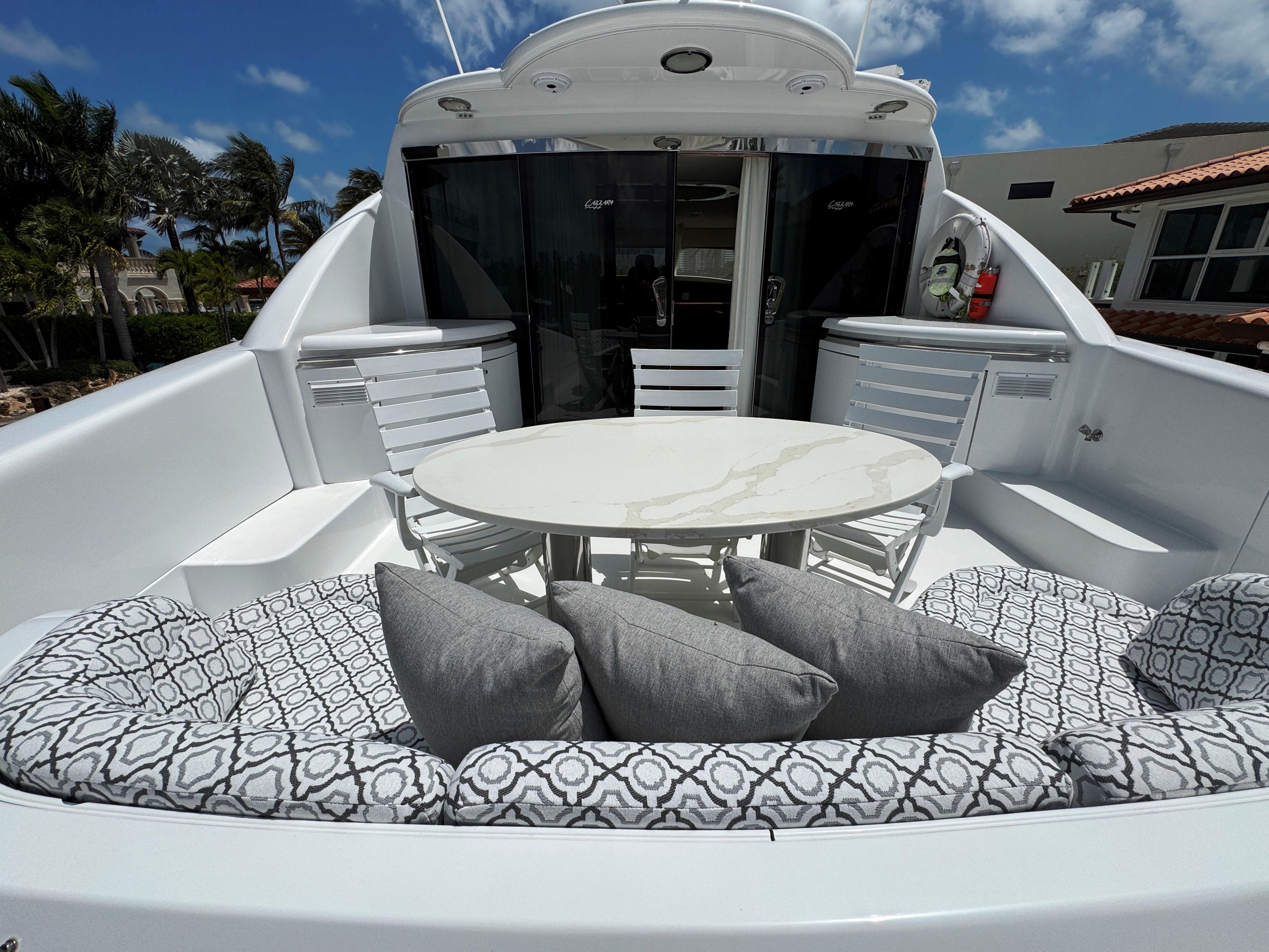 Lazzara-80 Skylounge 2002-Fomo2 FL-US-Luxurious 2002 Lazzara 80 Skylounge yacht with elegant outdoor seating and table.-9749638 | Thumbnail