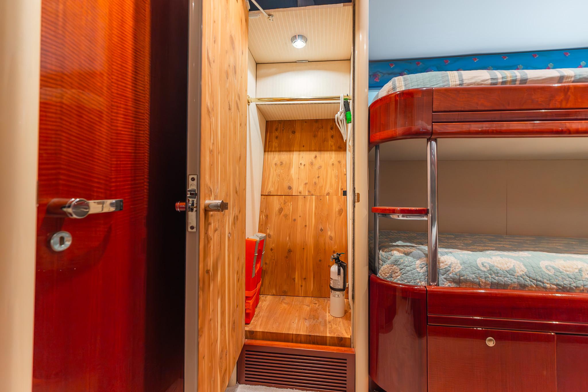 Lazzara-80 Skylounge 2002-Fomo2 FL-US-Interior of 2002 Lazzara 80 Skylounge yacht with wooden closet and bunk beds.-9749638 | Thumbnail