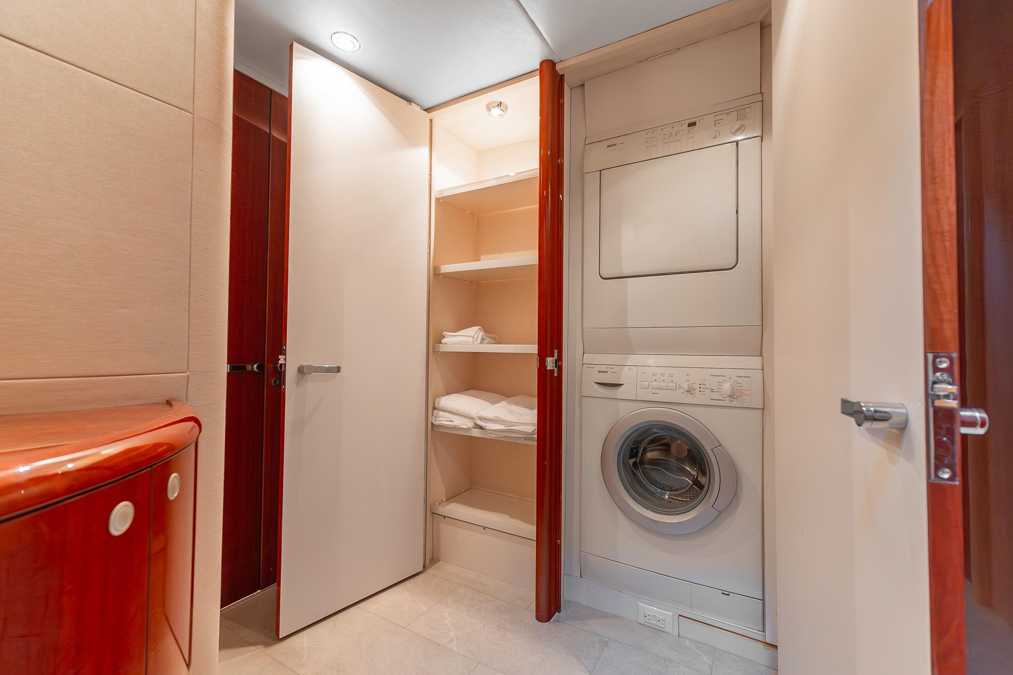 Lazzara-80 Skylounge 2002-Fomo2 FL-US-Laundry area with stacked washer and dryer in 2002 Lazzara 80 Skylounge yacht.-9749638 | Thumbnail