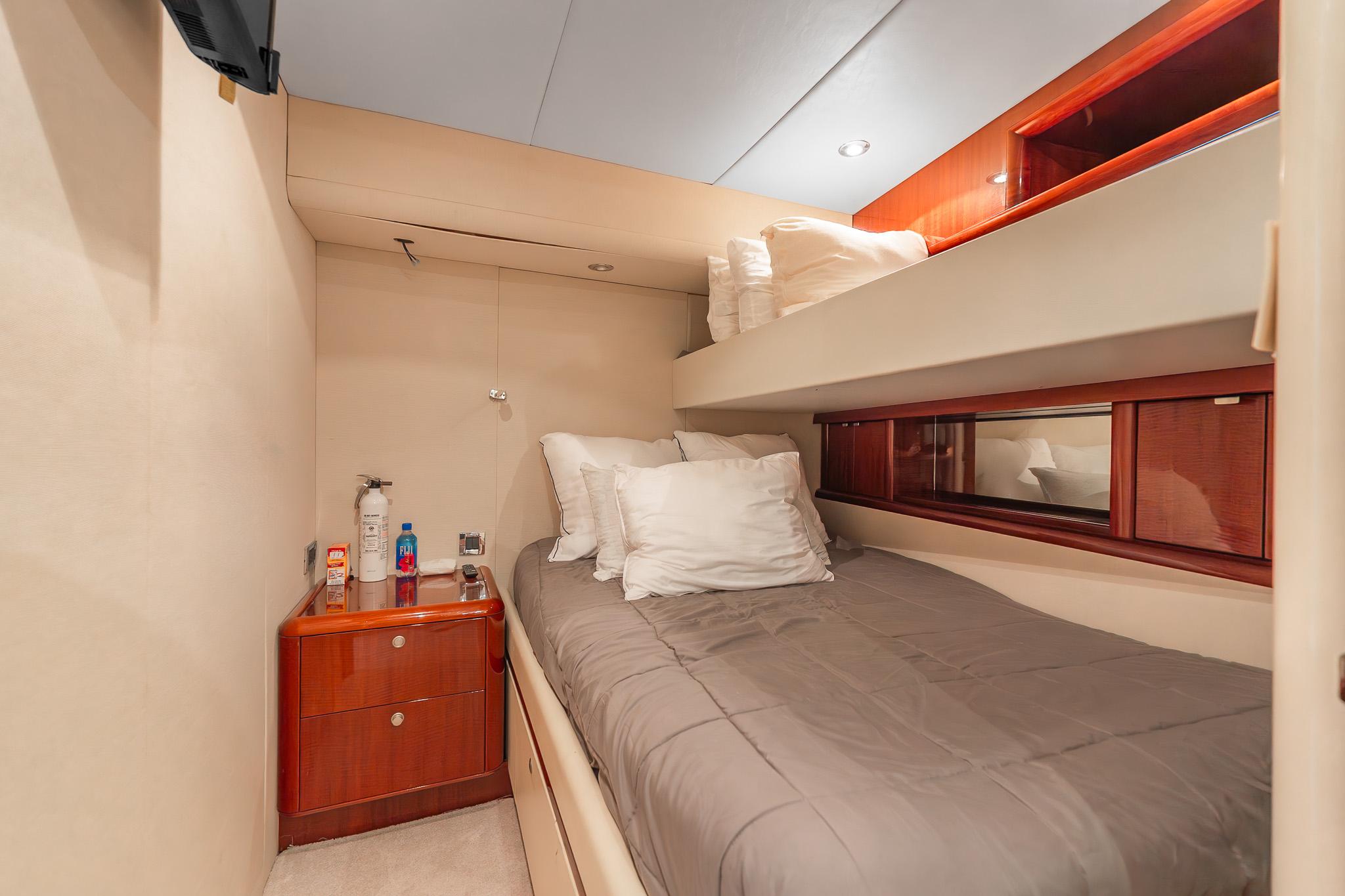 Lazzara-80 Skylounge 2002-Fomo2 FL-US-Cozy bedroom in 2002 Lazzara 80 Skylounge yacht with bunk beds and wooden accents.-9749638 | Thumbnail