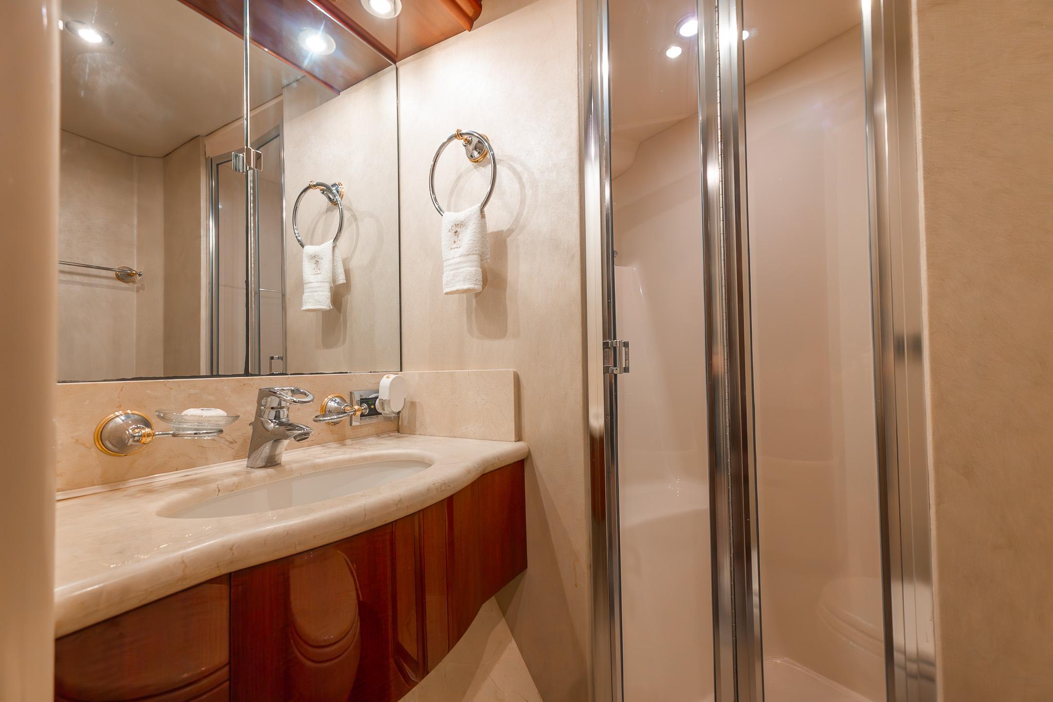 Lazzara-80 Skylounge 2002-Fomo2 FL-US-Luxurious bathroom in 2002 Lazzara 80 Skylounge yacht with elegant fixtures and shower.-9749638 | Thumbnail