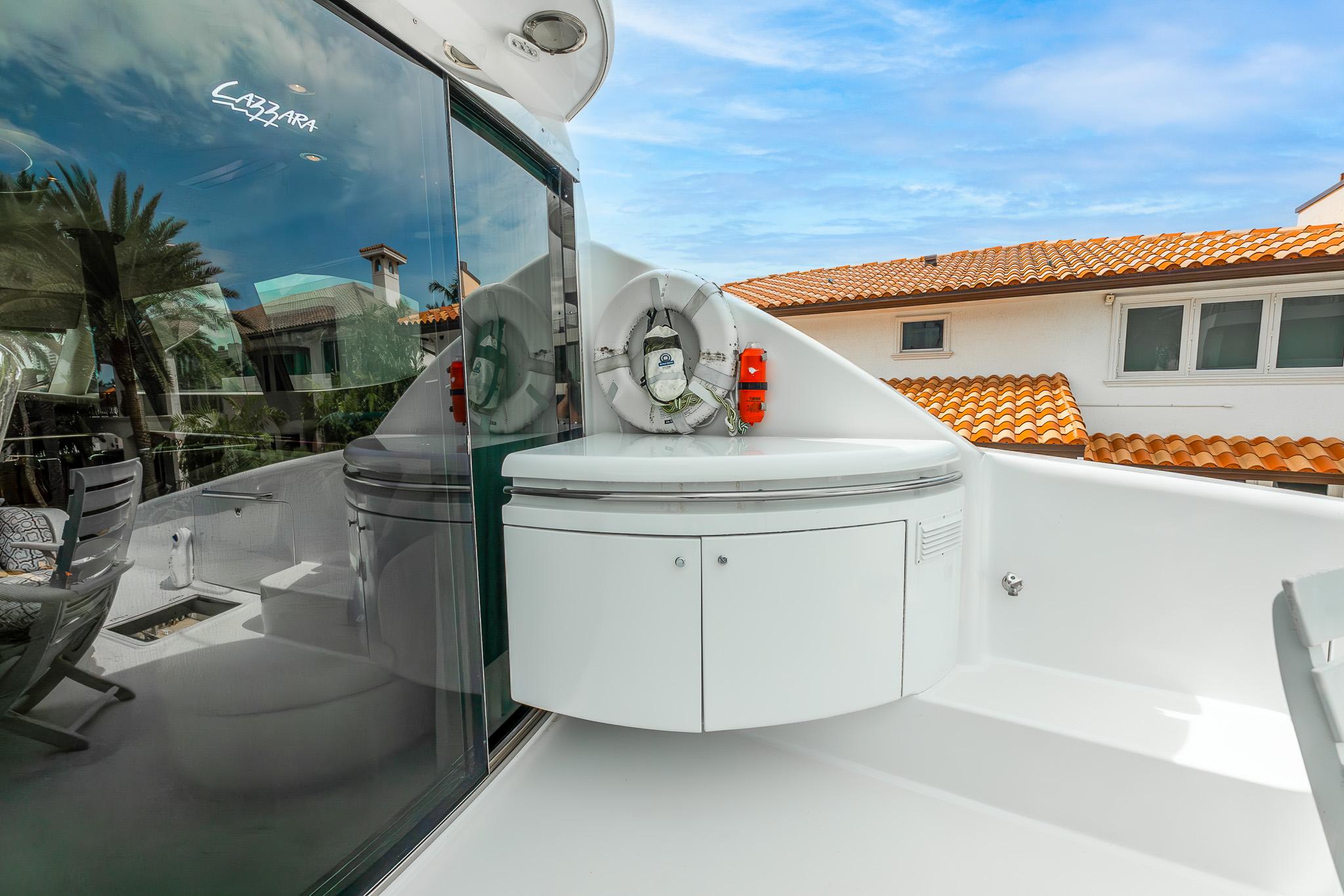 Lazzara-80 Skylounge 2002-Fomo2 FL-US-2002 Lazzara 80 Skylounge yacht deck with modern seating and safety equipment.-9749638 | Thumbnail