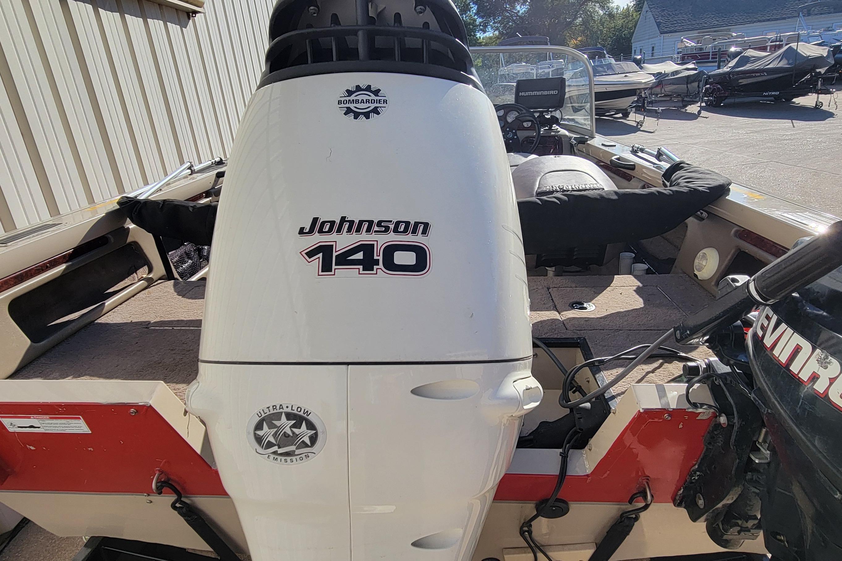 2007 Triton DV 176 Mag boat with Johnson 140 outboard motor in a marina setting.