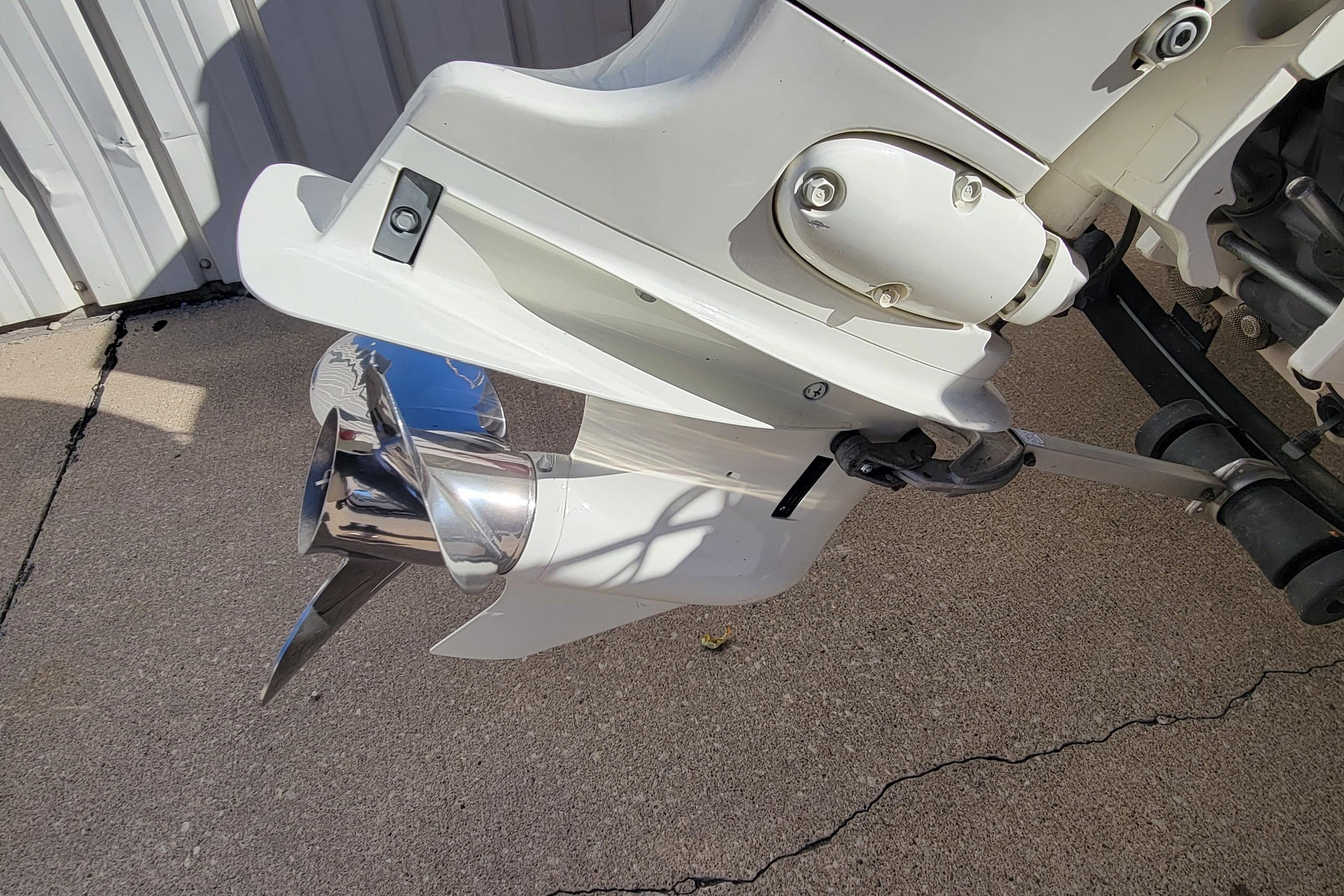 2007 Triton DV 176 Mag boat motor with shiny propeller on concrete surface.