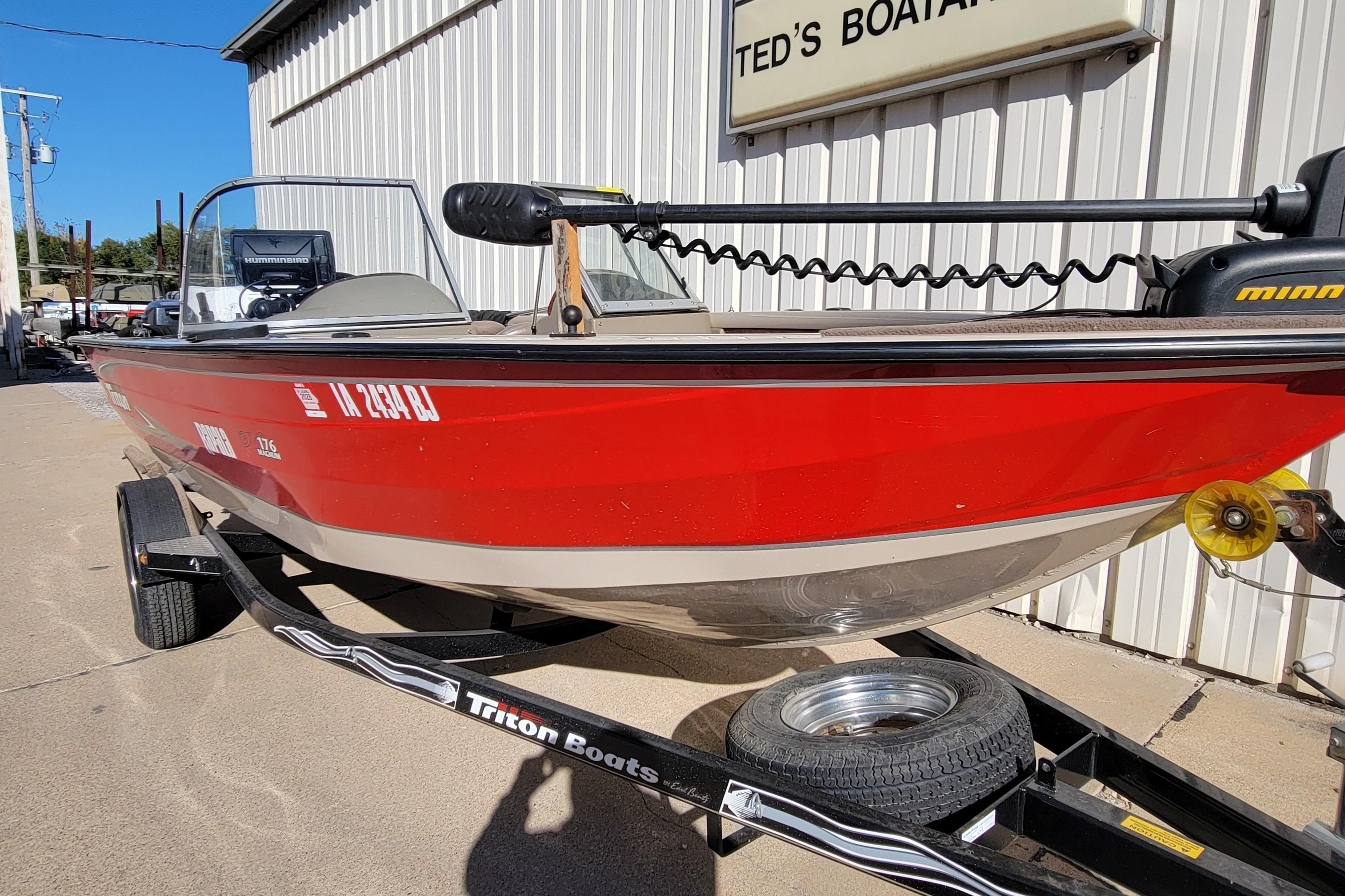 Red 2007 Triton DV 176 Mag boat on trailer outside Ted's Boating.