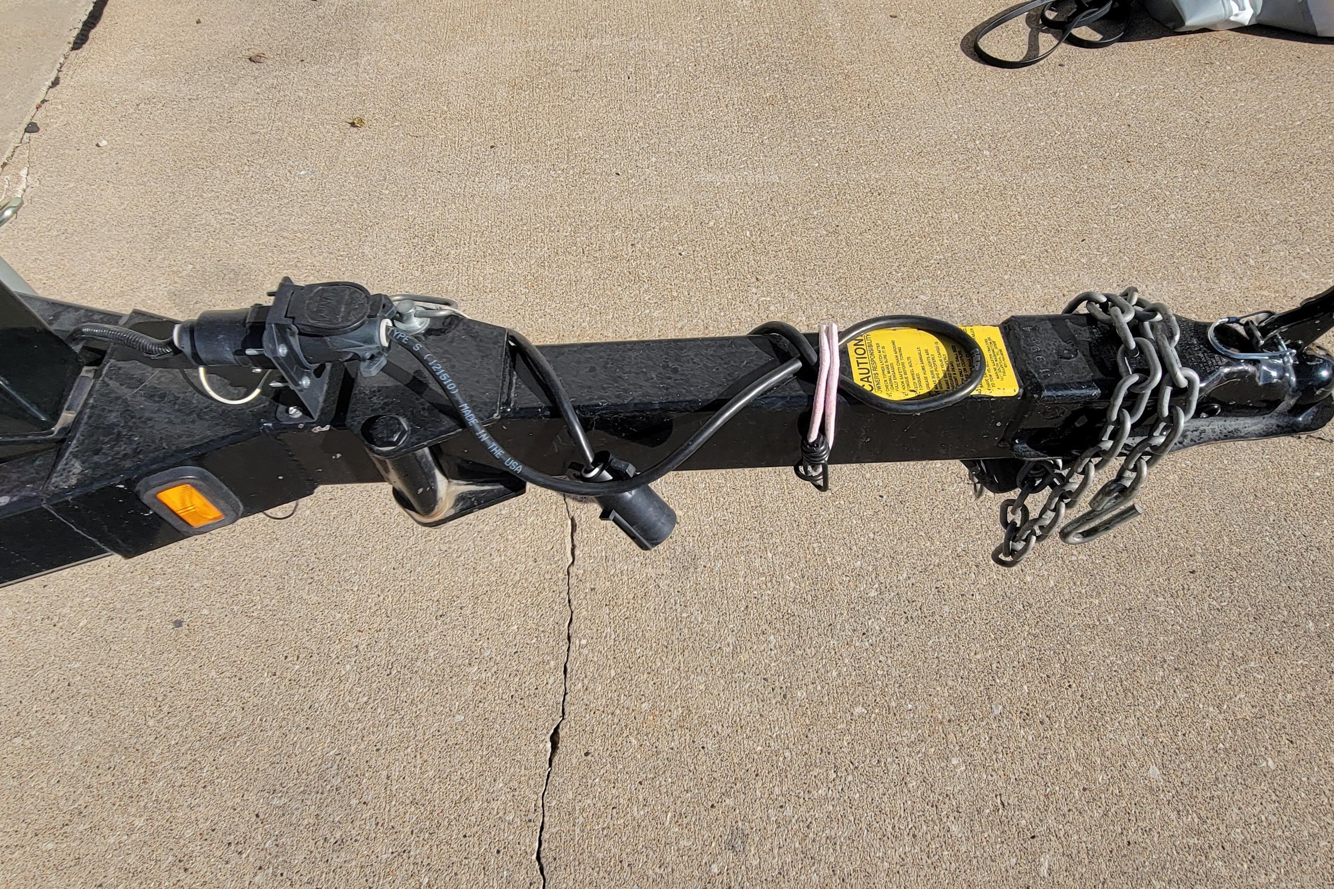 Trailer hitch of 2007 Triton DV 176 Mag with safety chains and wiring.