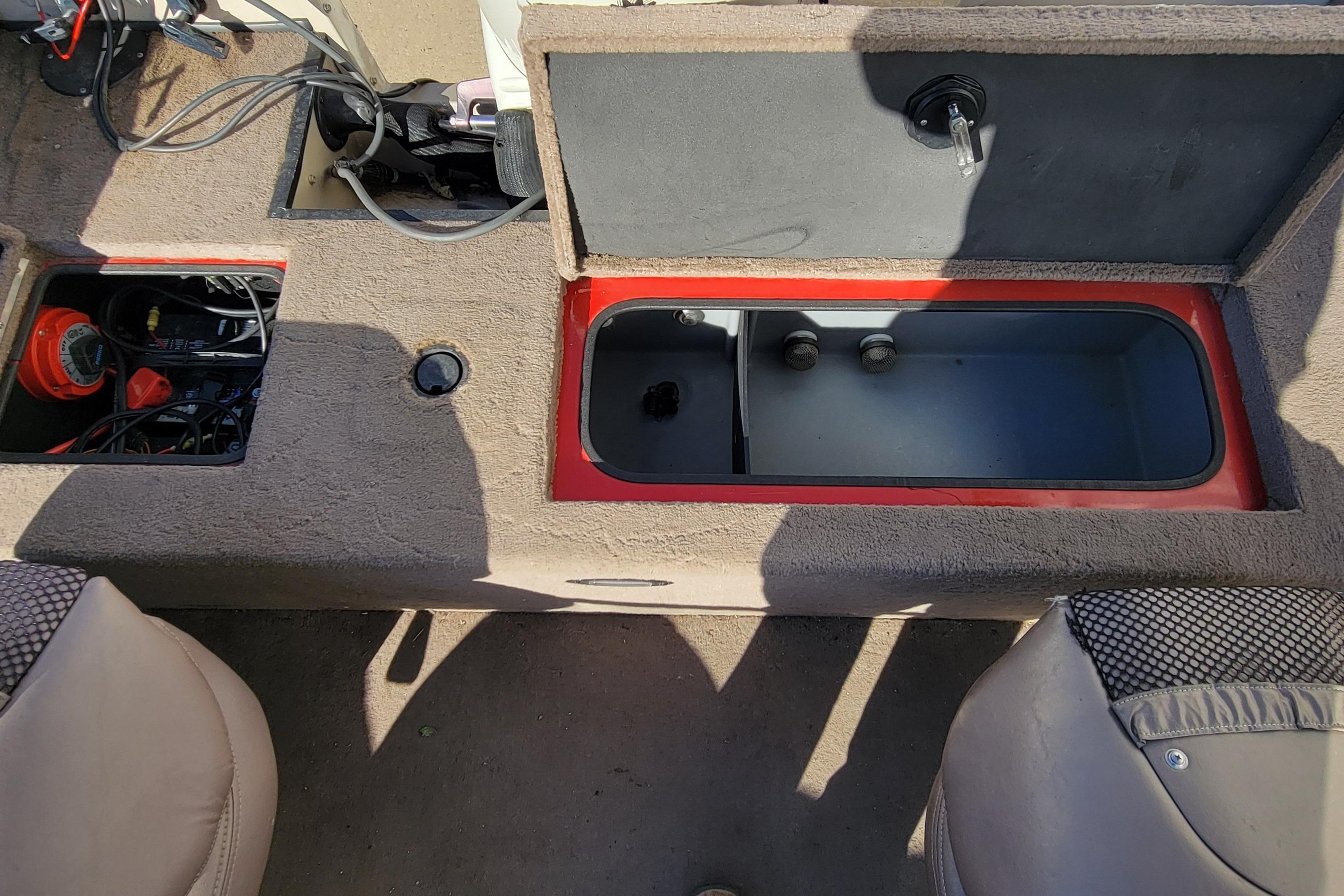 2007 Triton DV 176 Mag boat interior with open storage compartments and seating.