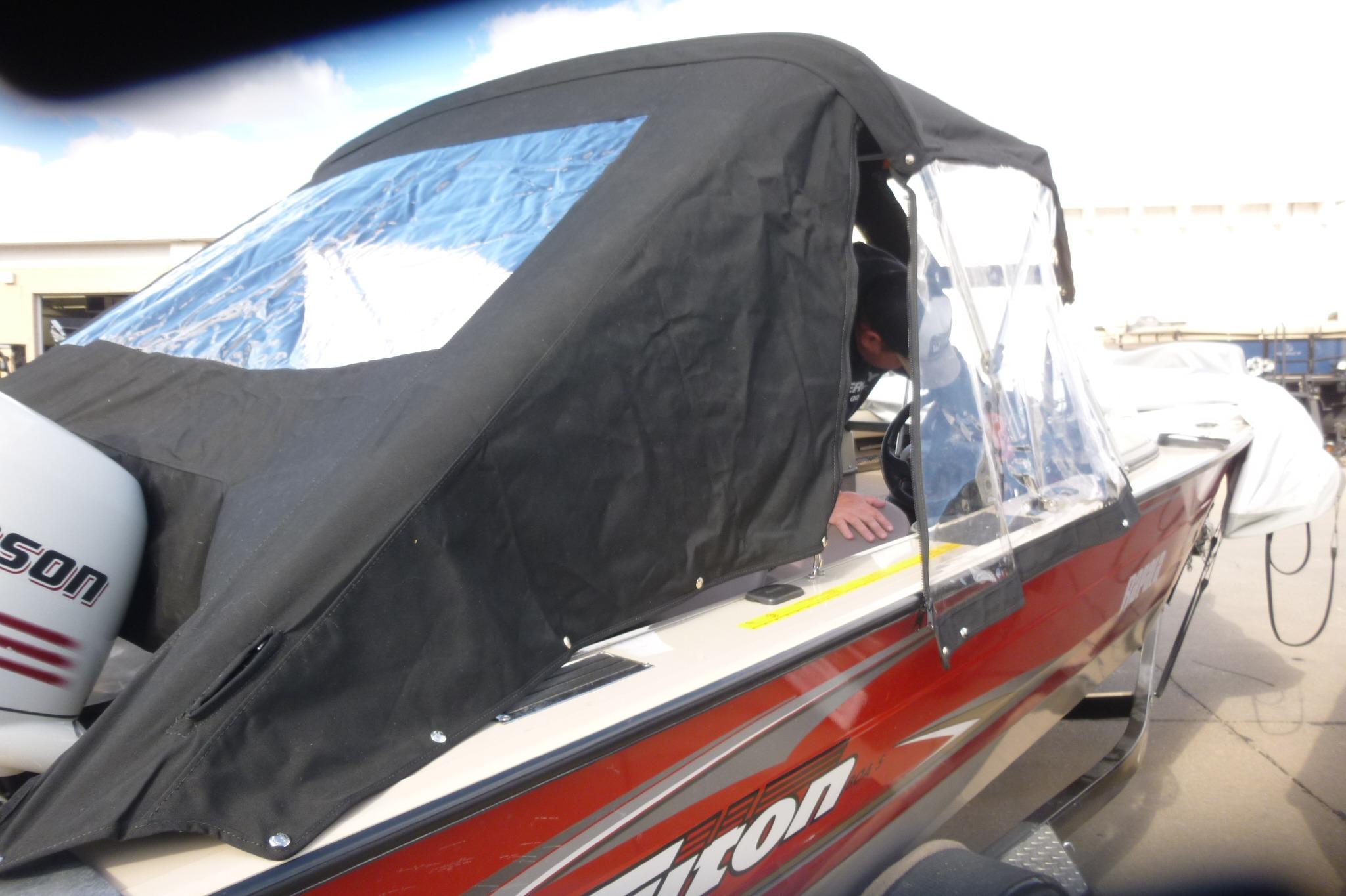 2007 Triton DV 176 Mag boat with black canopy and Johnson outboard motor.