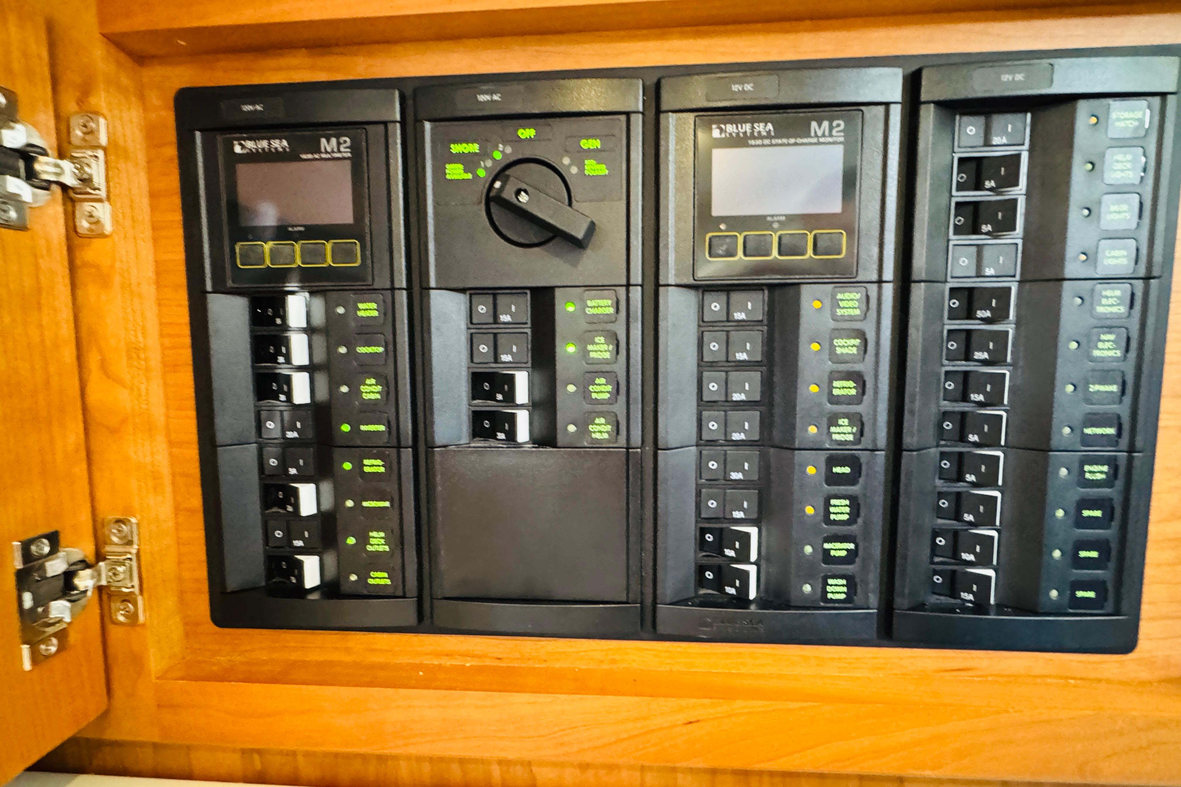 Electrical control panel on 2025 Back Cove 34O boat, featuring multiple switches and displays.