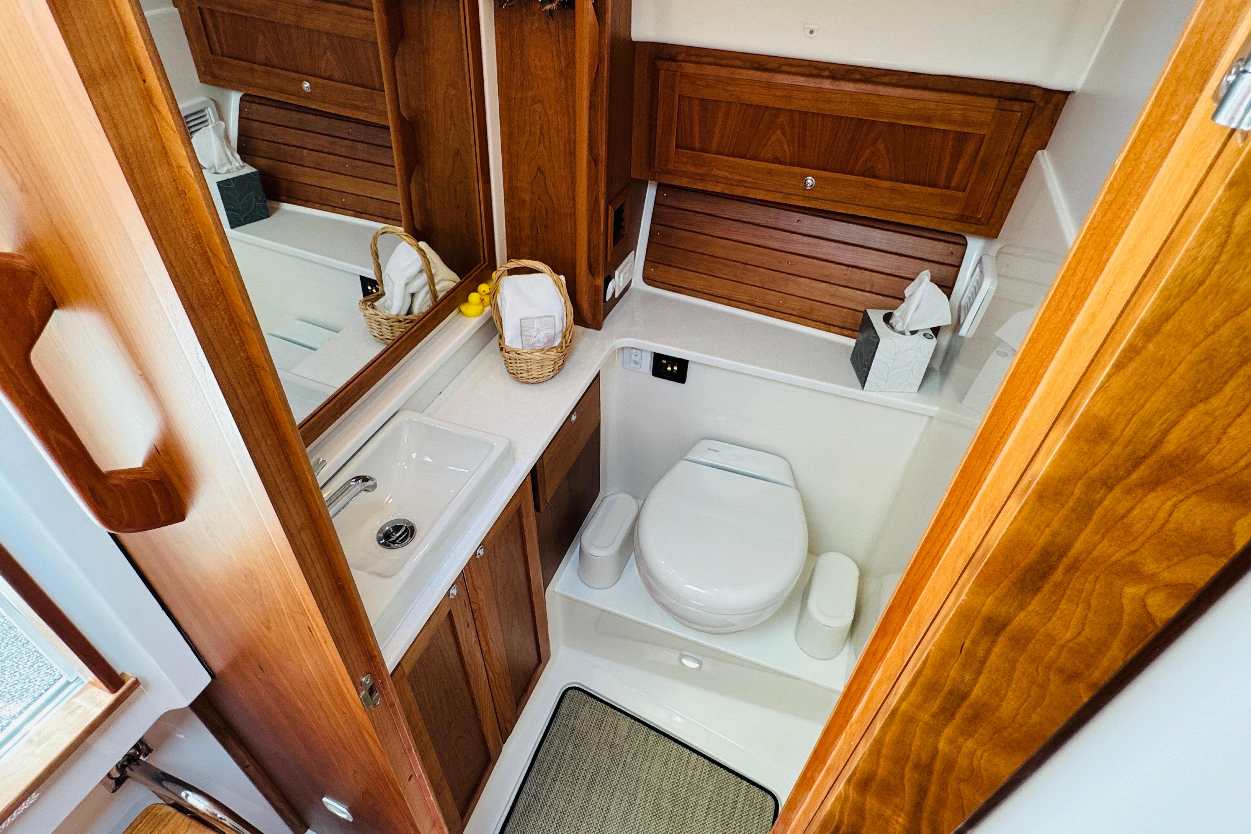 Luxurious 2025 Back Cove 34O yacht bathroom with wooden cabinetry and modern fixtures.