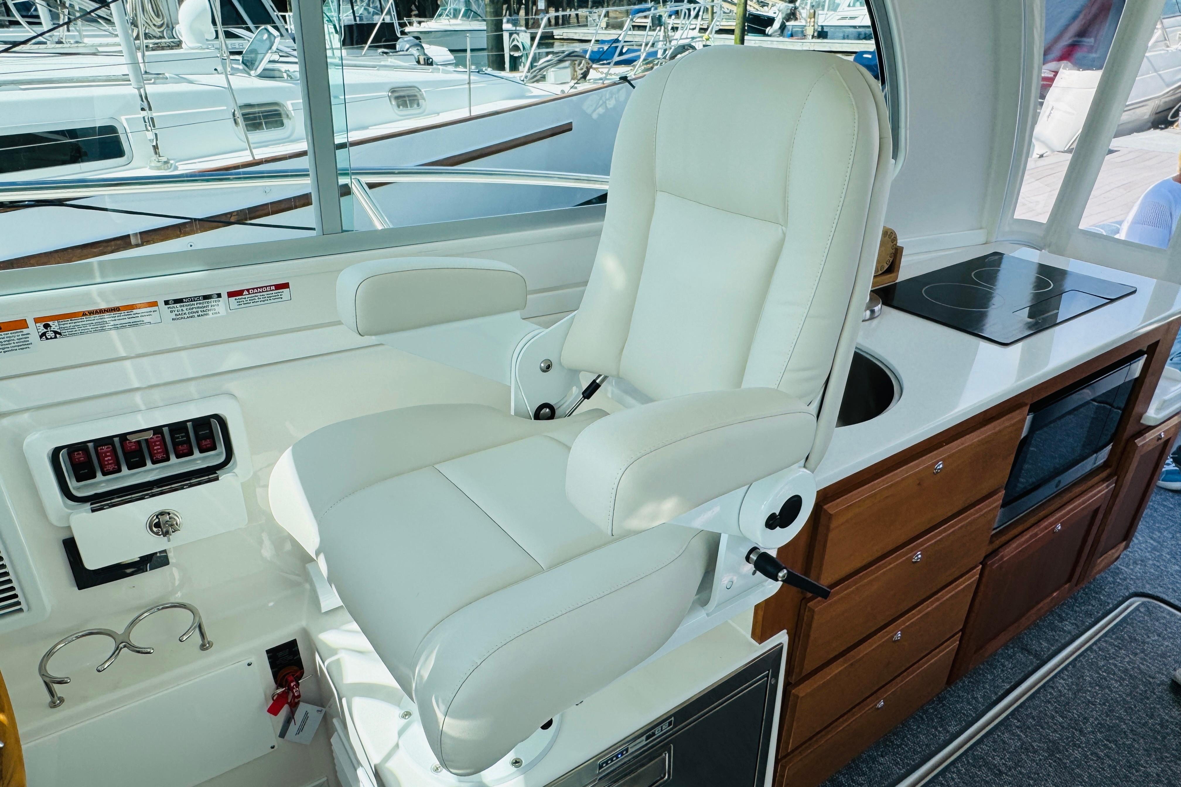 Luxury helm seat and galley in 2025 Back Cove 34O yacht interior.