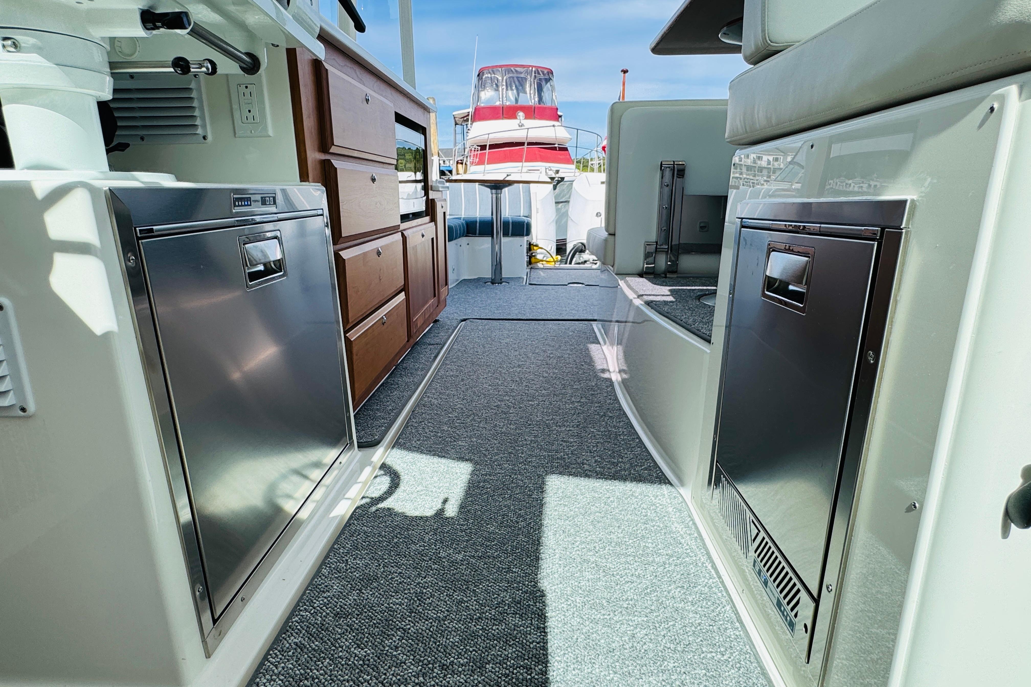 2025 Back Cove 34O yacht interior with modern appliances and wooden cabinetry.