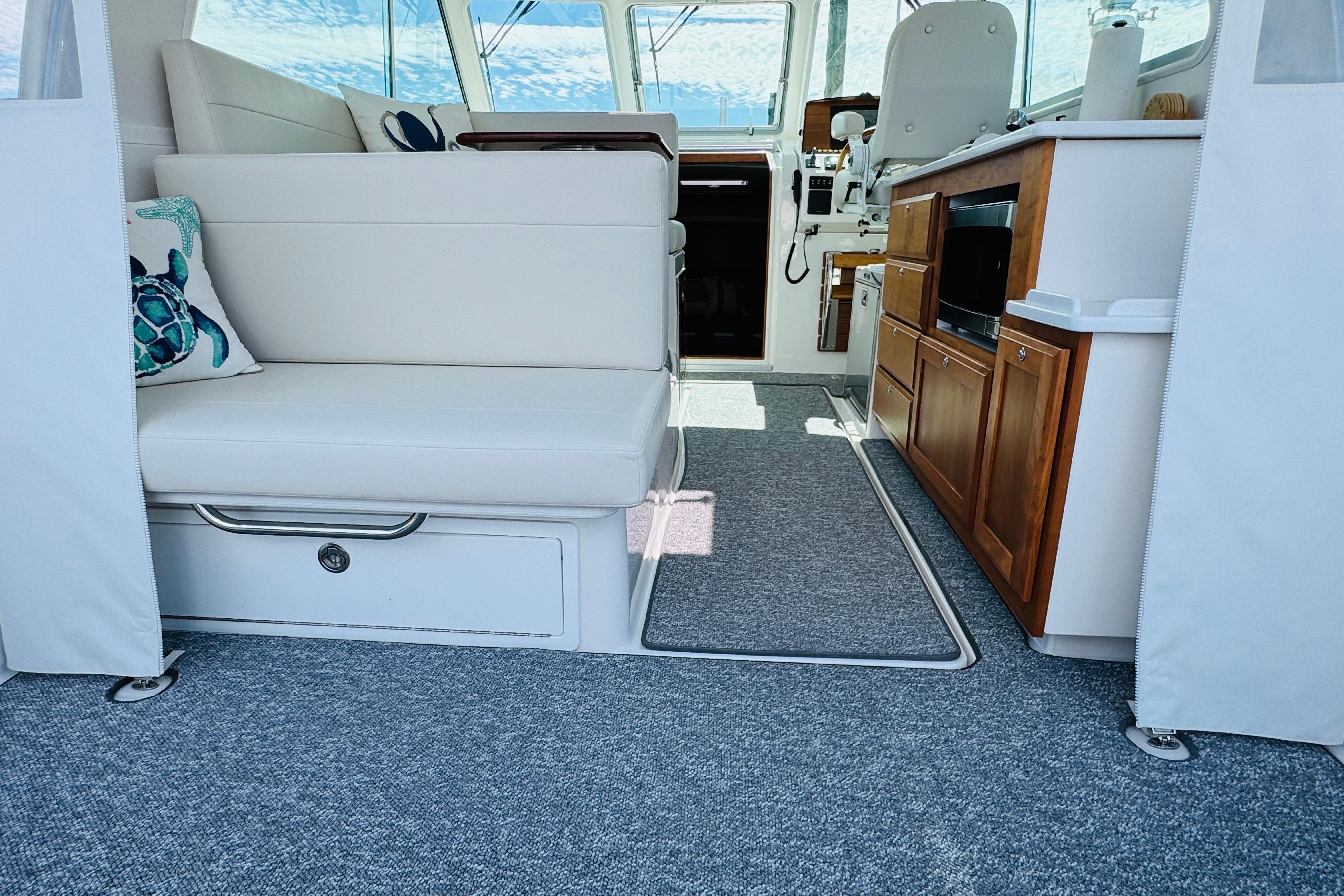 Interior of 2025 Back Cove 34O boat with seating and kitchenette.