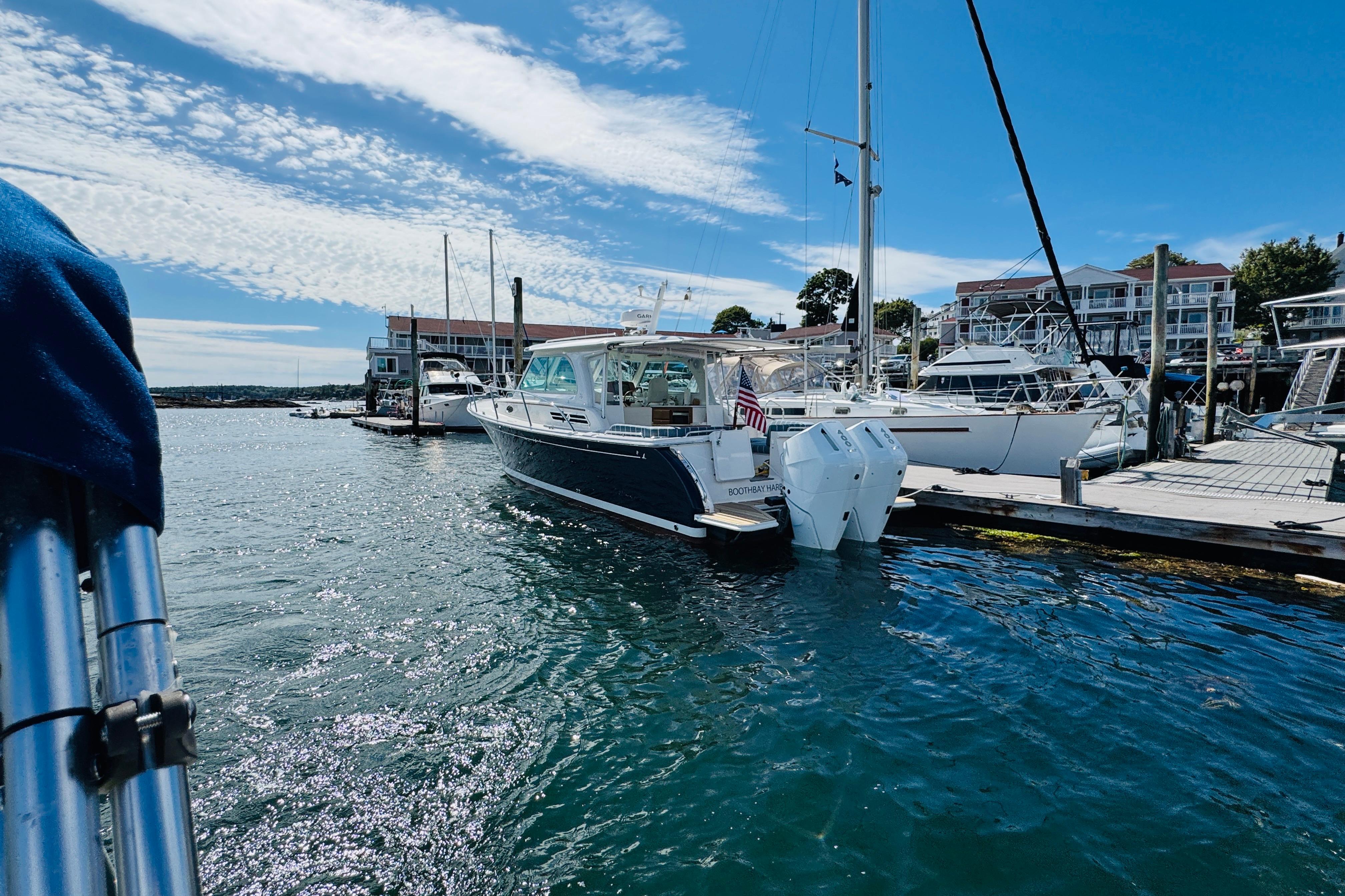 2025 Back Cove 34O boat docked in a sunny marina with clear blue skies.