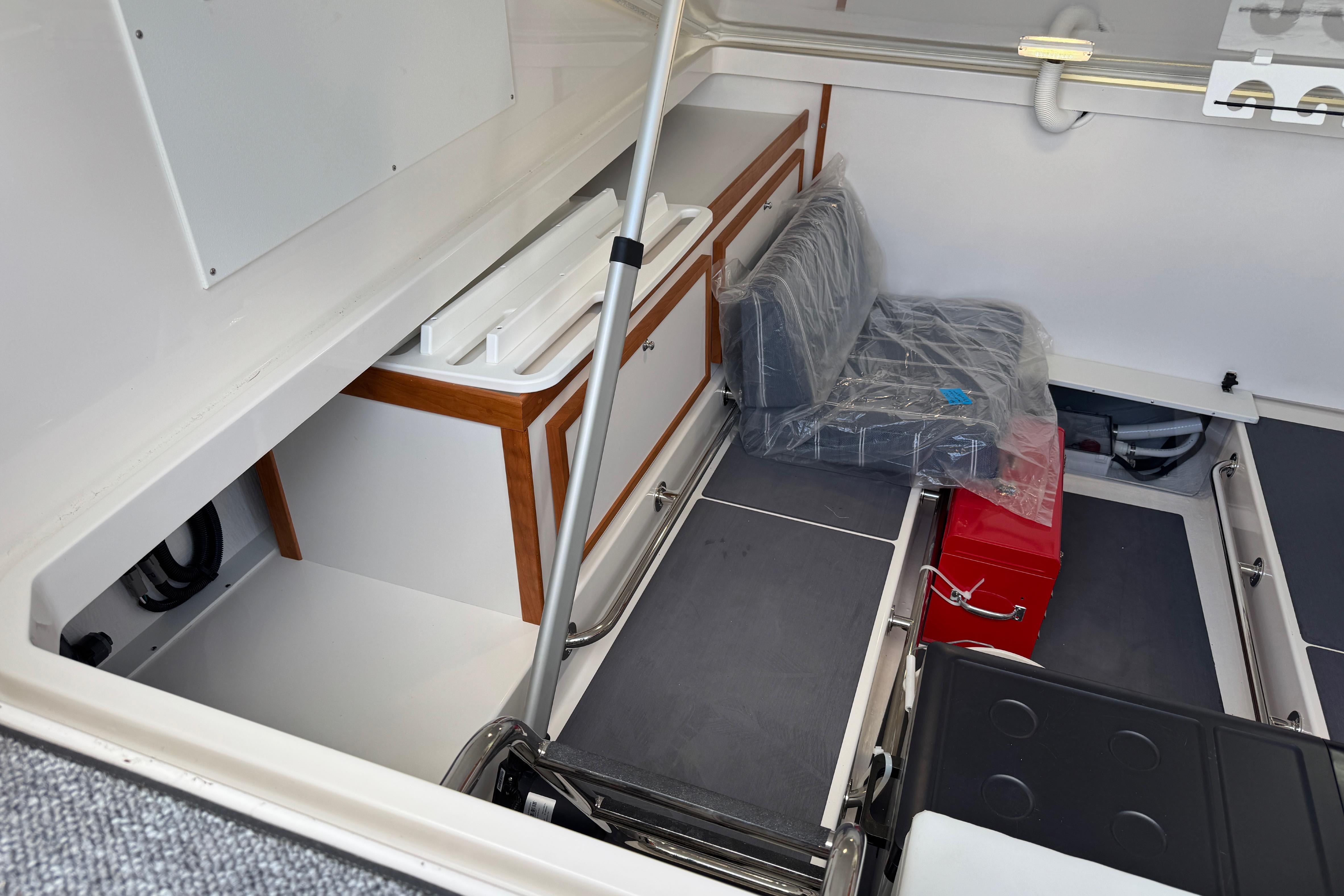 2025 Back Cove 34O boat interior storage area with seating and equipment.